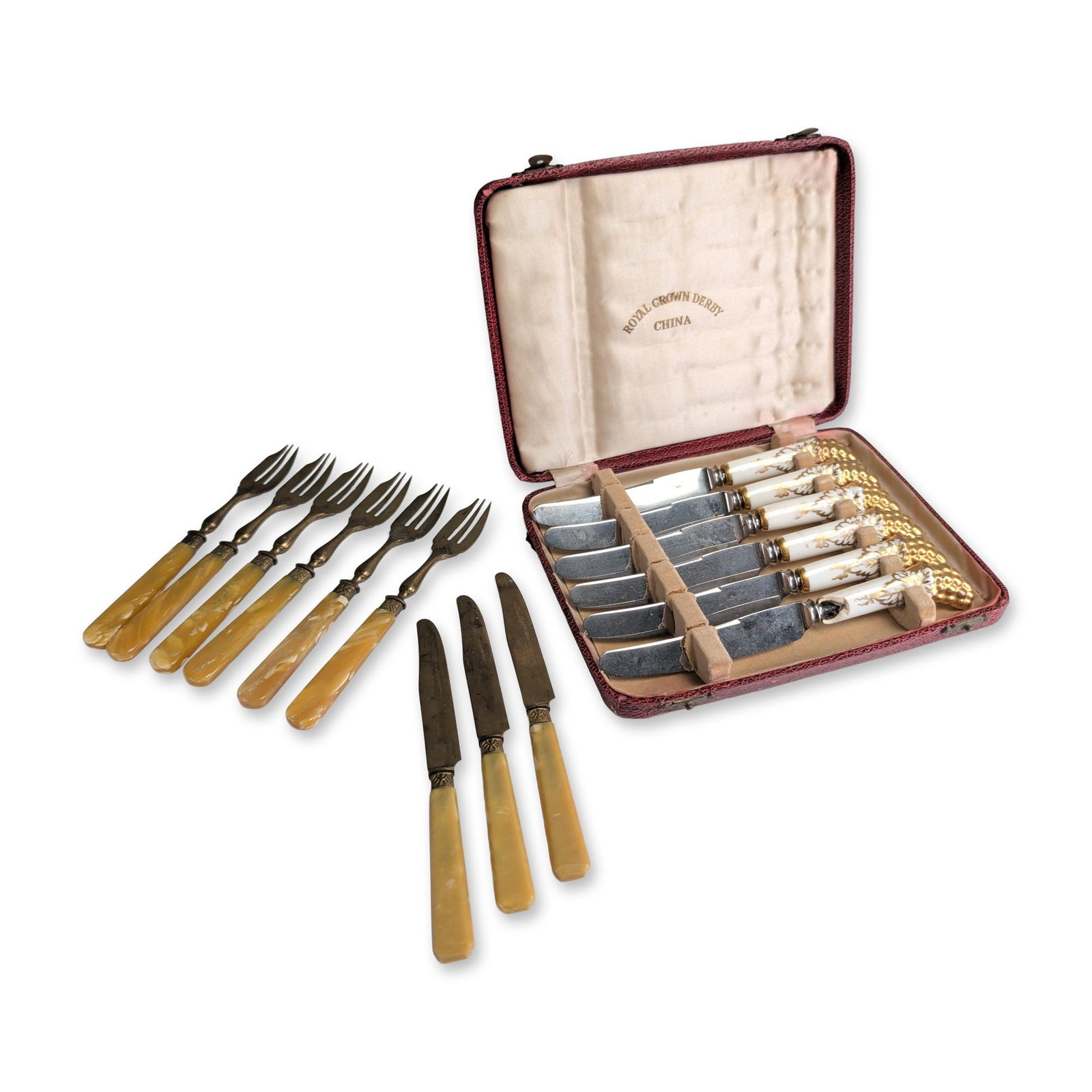 10pc Royal Crown Derby Tea Knives and Assorted Flatware: Royal Crown Derby English tea knife set and nine hors d oeuvre flatware. The Royal Crown Derby set includes six knives featuring stainless steel blades and porcelain handles decorated with a white gro