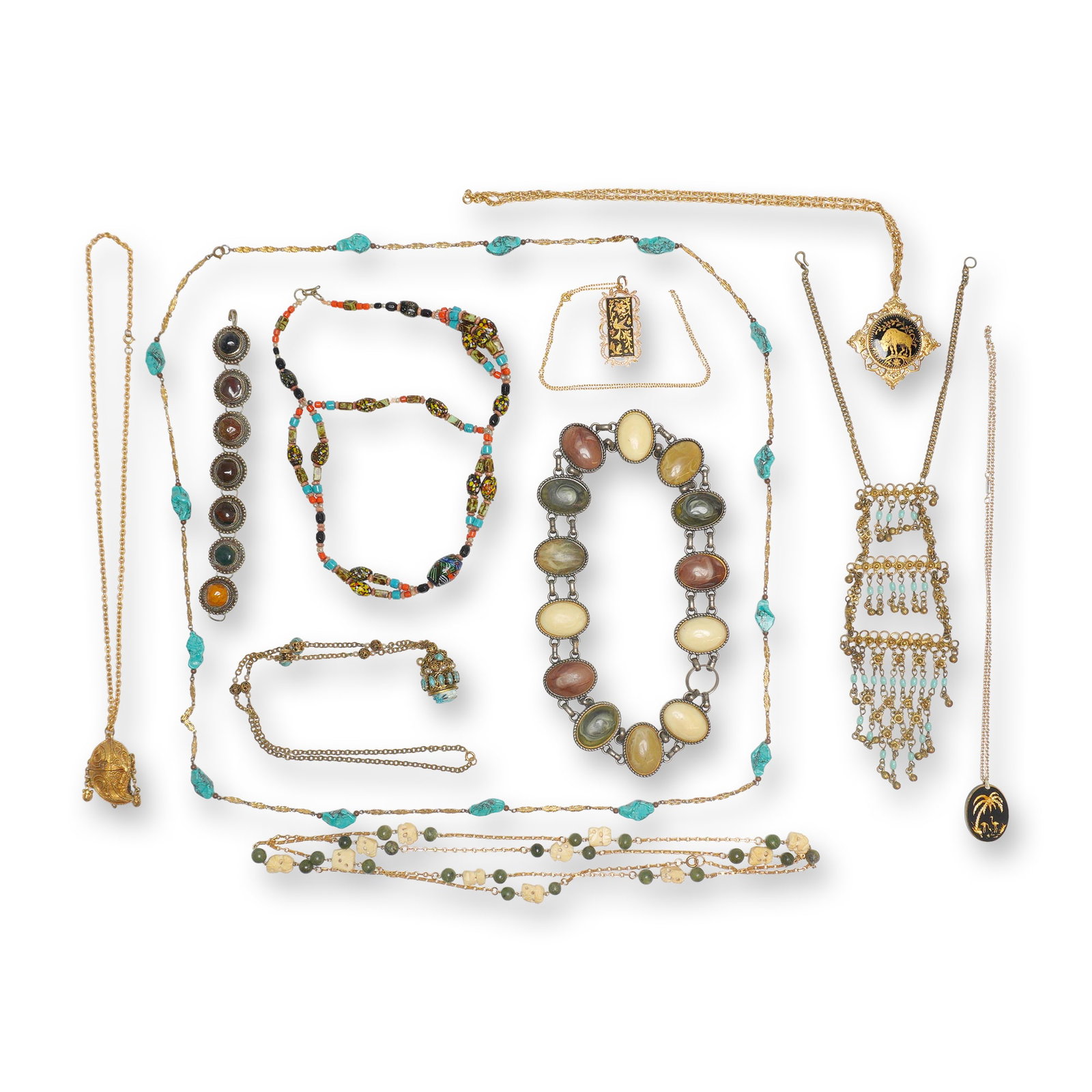 Gold and Silver-Tone Costume Jewelry Lot, Egyptian Revival and Tribal Styles: This 11-piece jewelry lot consists of ten necklaces and one bracelet featuring a variety of vintage and costume designs. The collection includes an Egyptian Revival Pharaoh head pendant with a carved 