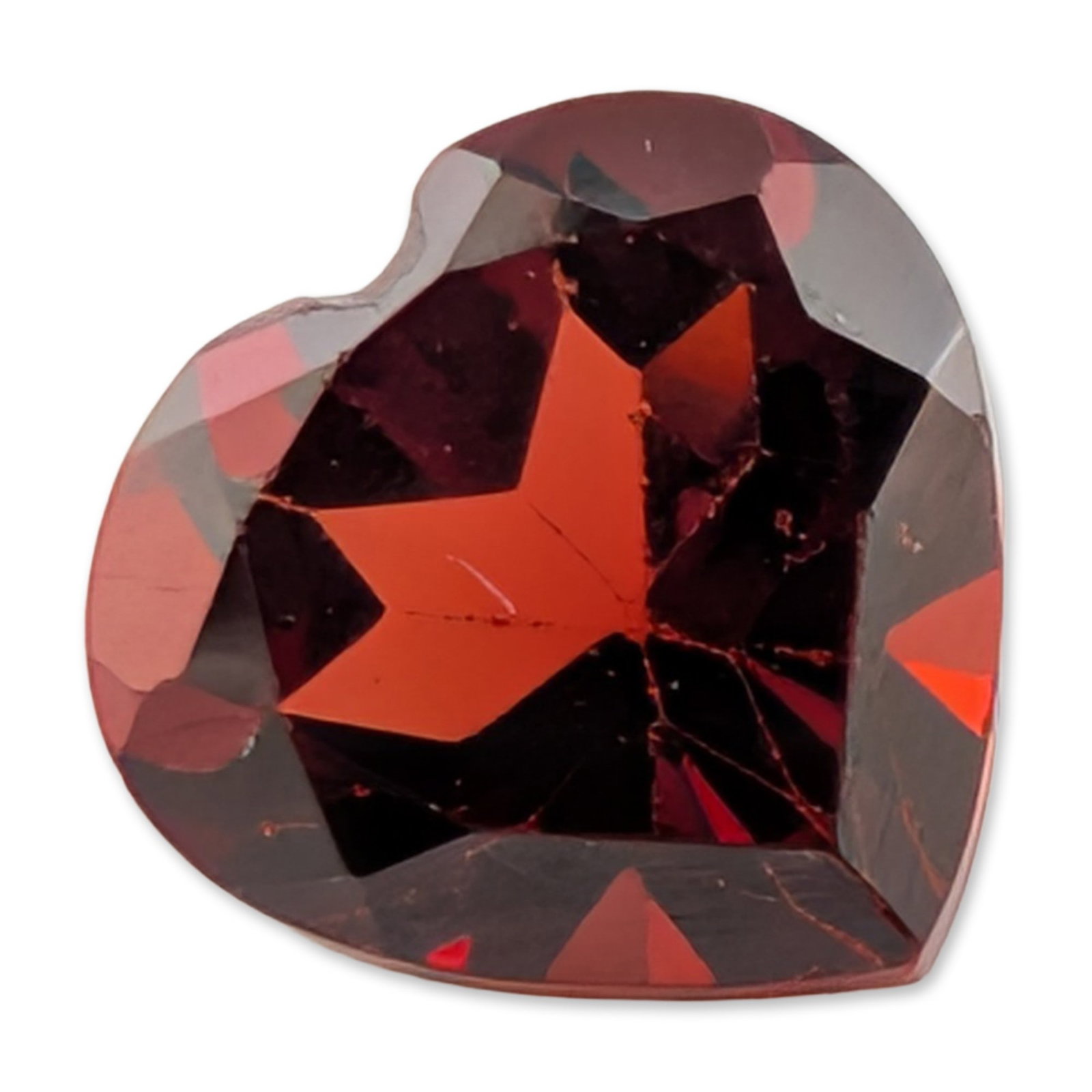 Heart Shaped Red Garnet Gemstone: Heart shaped mixed cut gemstone featuring a saturated deep red hue with internal brilliance and transparency. The stone appears to be a variety of natural garnet, such as almandine or pyrope.5.8 x 5.8