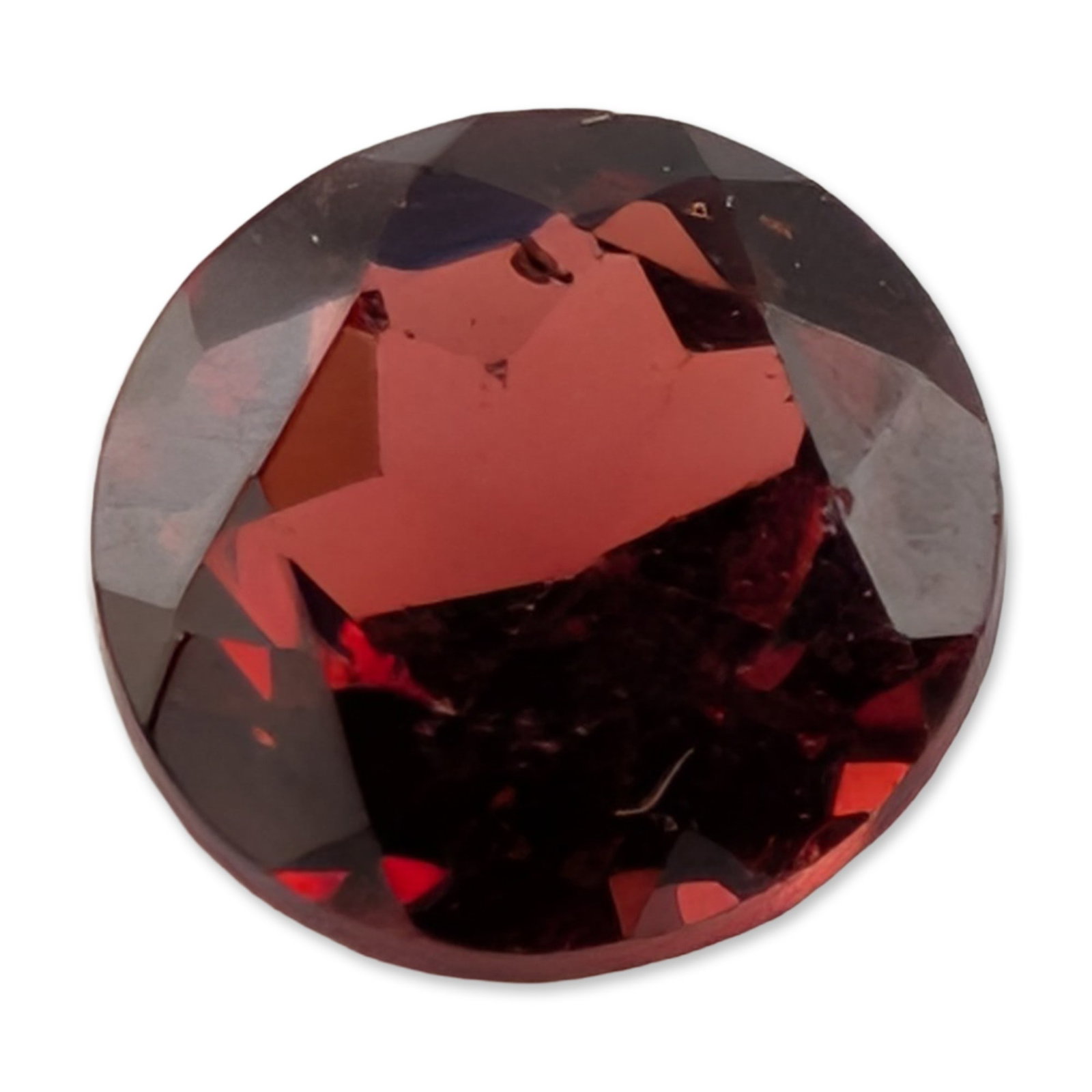 Round Brilliant Cut Red Gemstone: Loose round brilliant cut red gemstone, appearing to be a variety of garnet based on color and saturation. The stone features a deep, saturated red tone with secondary brownish undertones. Faceted in 