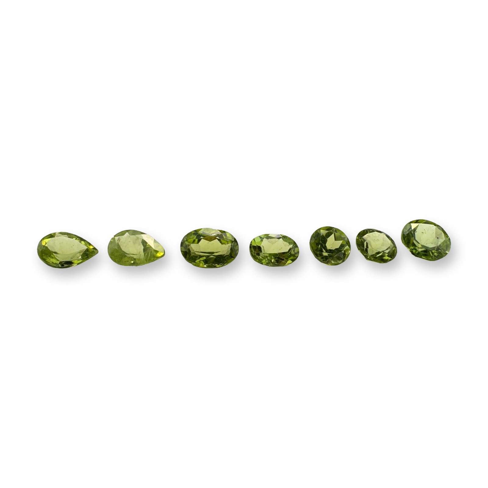 7pc Various Shapes Peridot Gemstones: Beautiful grouping of 7 Peridot stones in various shapes. Green peridot is a vibrant, August birthstone renowned for its unique single-color profile-ranging from bright lime to deep olive green.Tested