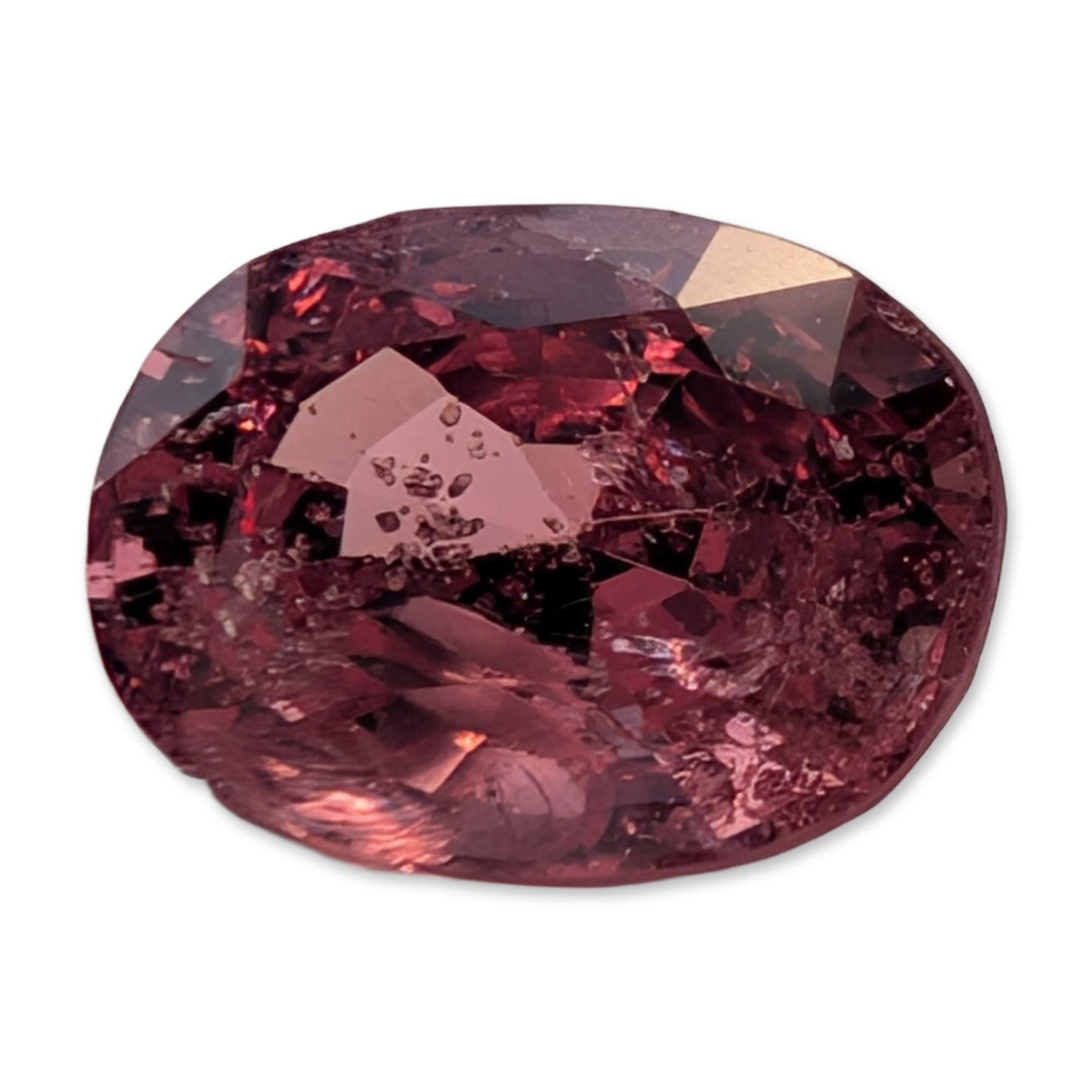Loose Oval Mixed-Cut Pink Sapphire Gemstone: Loose faceted gemstone worked in an oval mixed-cut with a faceted crown and pavilion. It exhibits a saturated pink color with secondary purplish undertones. Internal characteristics include prominent 