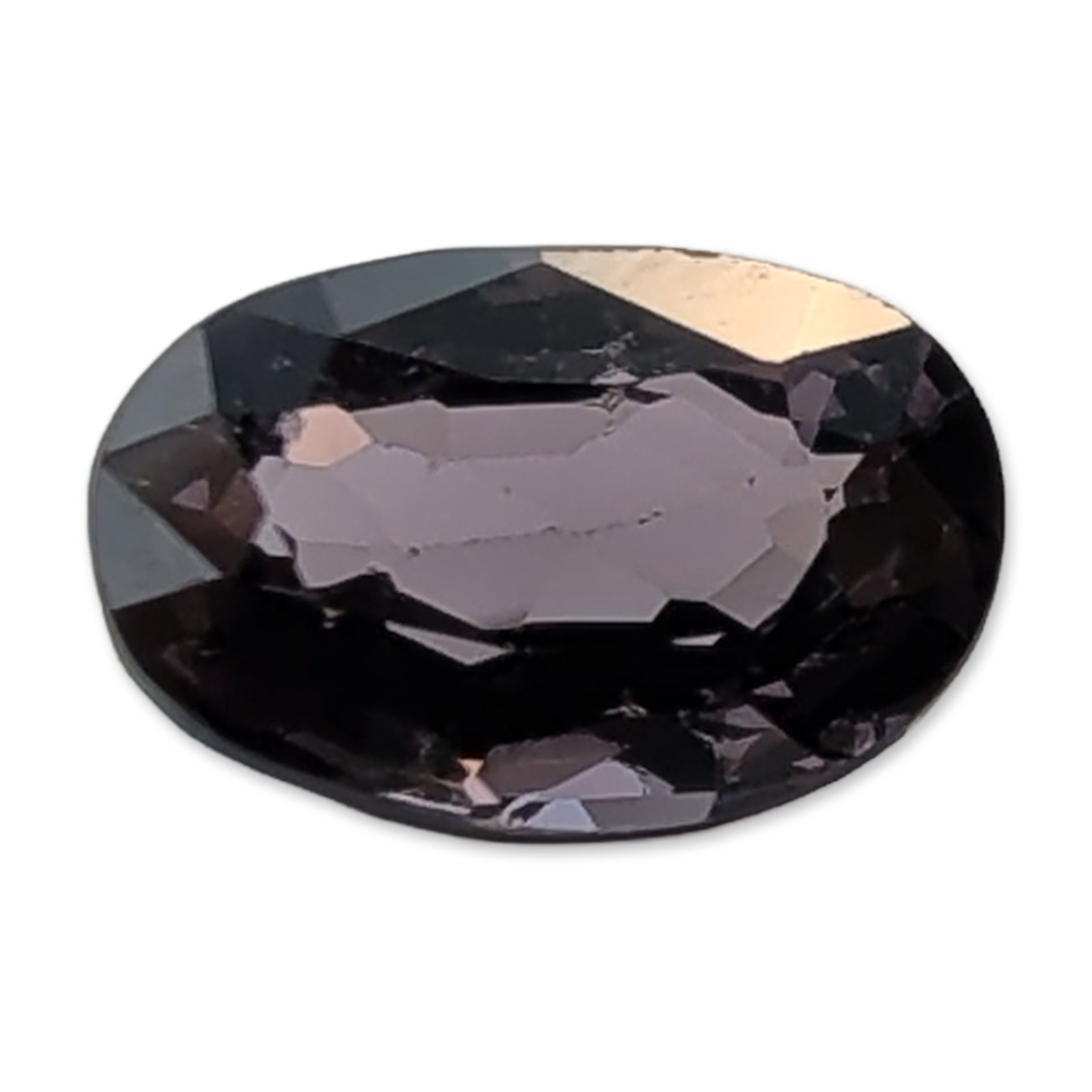 Natural Purple Spinel Oval Cut Faceted Gemstone: Loose faceted spinel gemstone, featuring an oval cut in a deep mauve to smoky purple hue. The stone is faceted on the crown and pavilion. An internal inclusion or linear fracture is visible through th