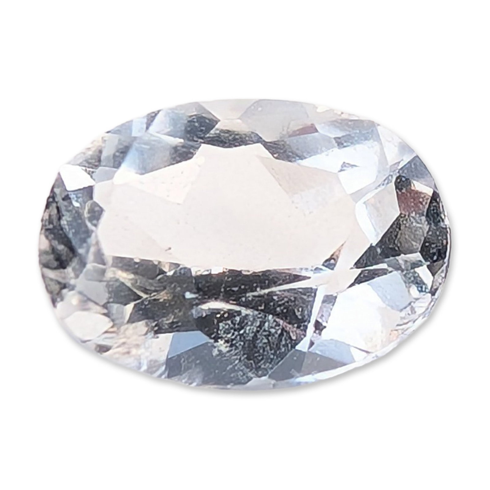 Oval Cut Loose White Topaz Gemstone: Oval faceted loose gemstone, colorless to near-colorless in appearance with a possible faint blue tint. The stone exhibits good clarity with no significant eye-visible inclusions and features sharp fa