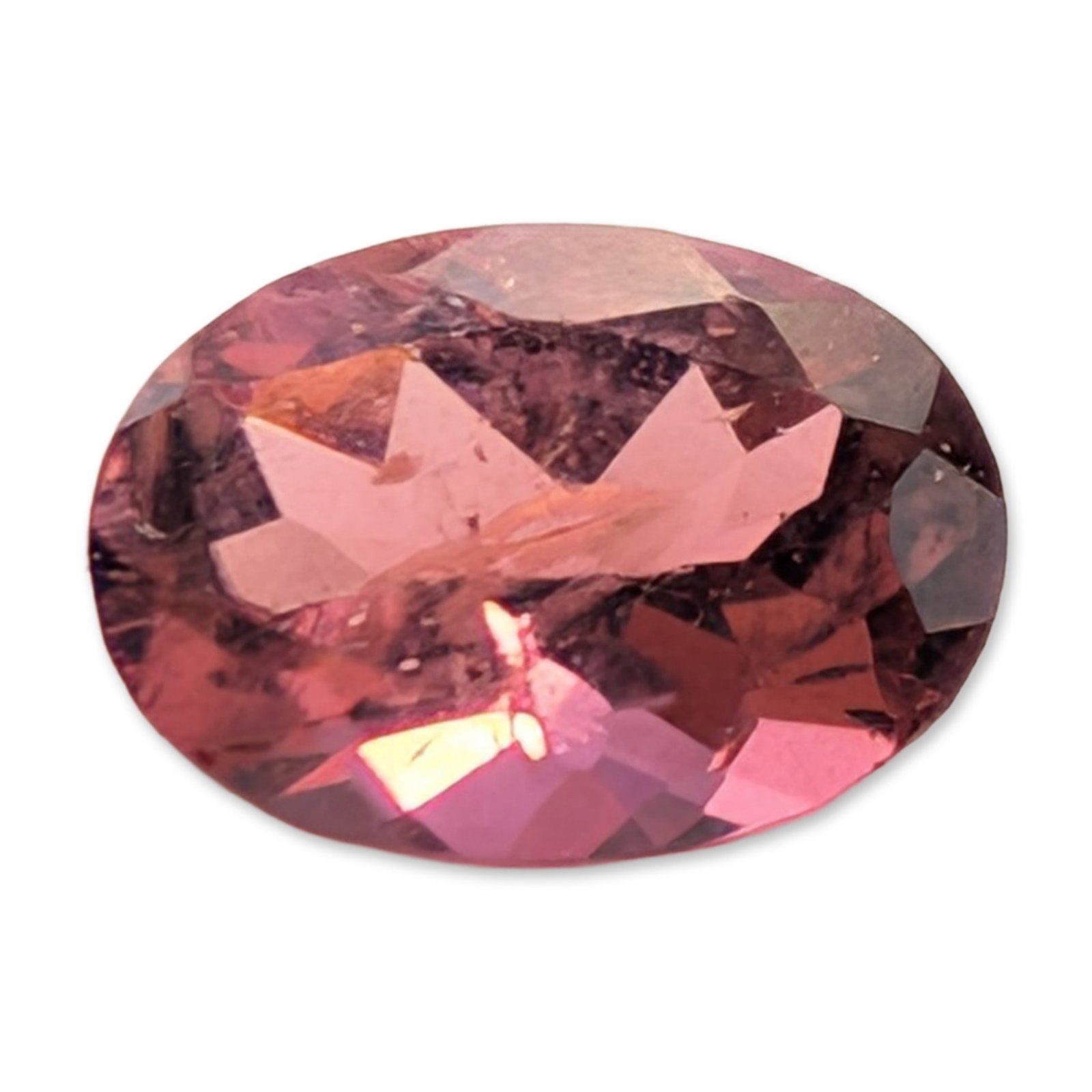 Oval Cut Faceted Pink Tourmaline: A loose faceted gemstone, appears to be a pink tourmaline, featuring an oval modified brilliant cut. The stone displays a saturated pinkish-purple to magenta hue. Internal characteristics include a pr