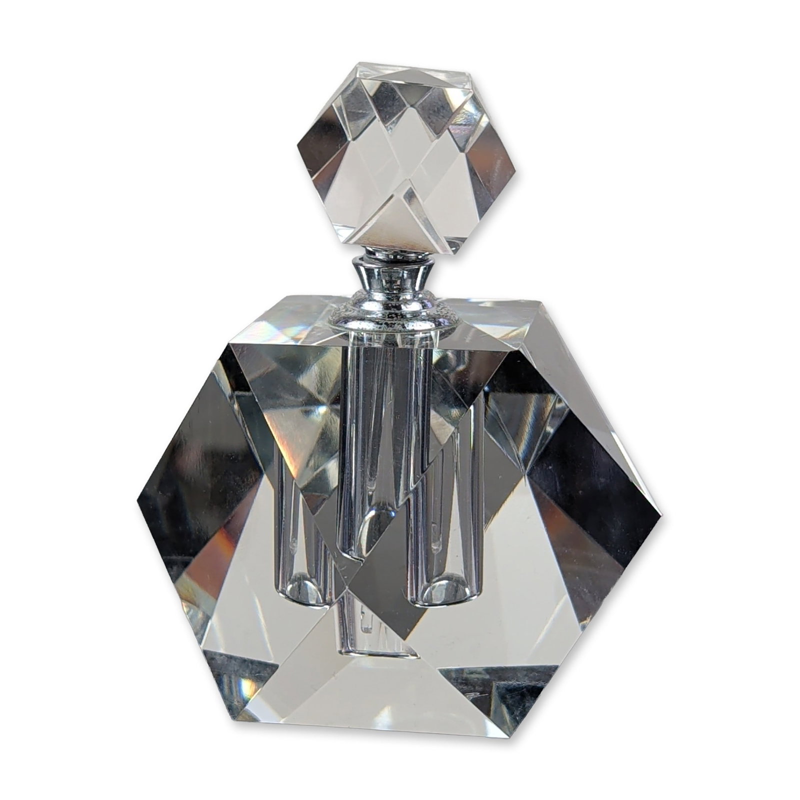 Oleg Cassini Faceted Crystal Perfume Bottle: Oleg Cassini. Perfume bottle in clear faceted lead crystal, featuring a geometric block form with multiple sharp cut facets and a matching faceted stopper. The piece is constructed with a central cyli