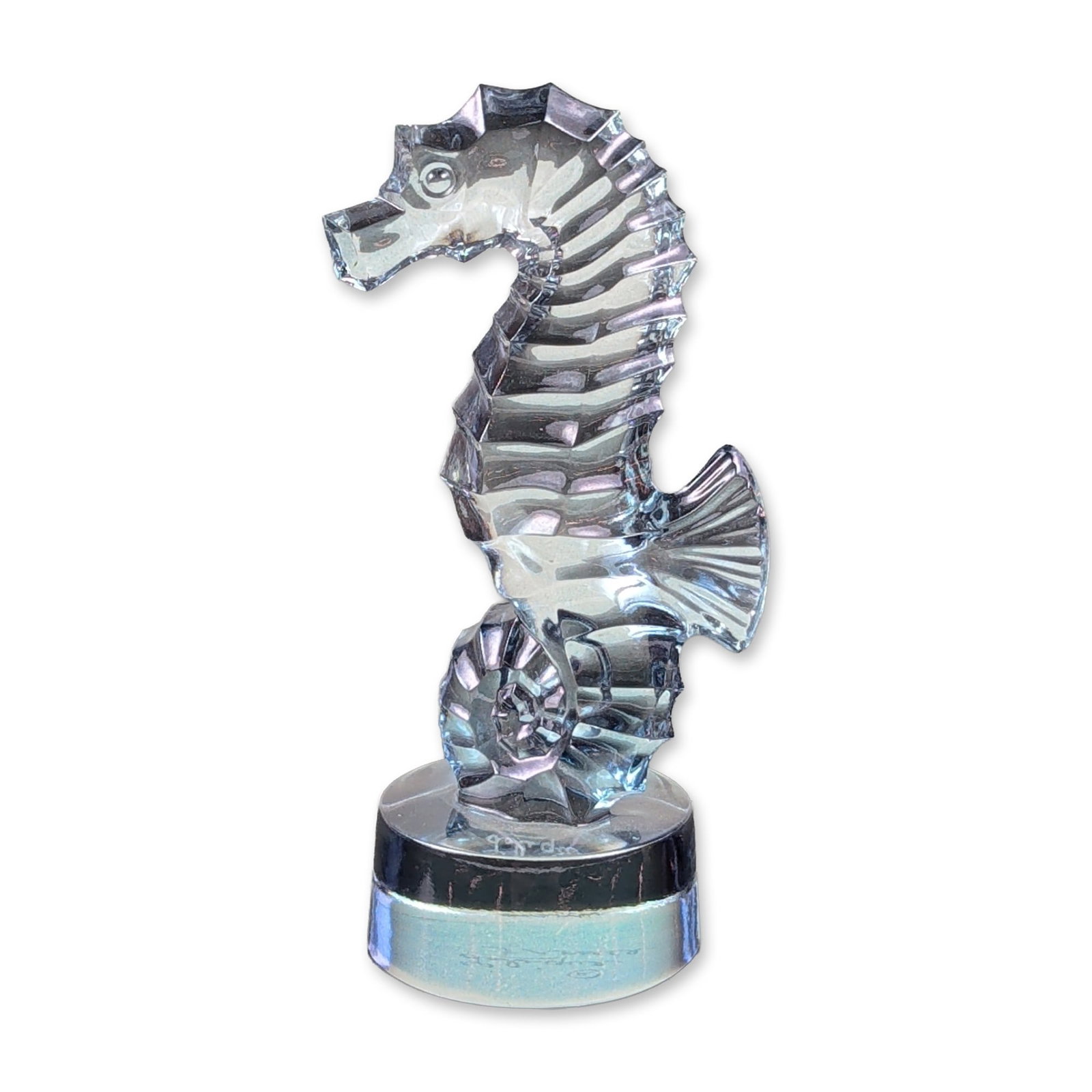 Lalique France Frosted Crystal Seahorse Figurine: Lalique lead crystal seahorse figurine featuring a combination of polished clear and satin-finished frosted finishes to define the anatomical details of the segmented body and fins. The circular base 