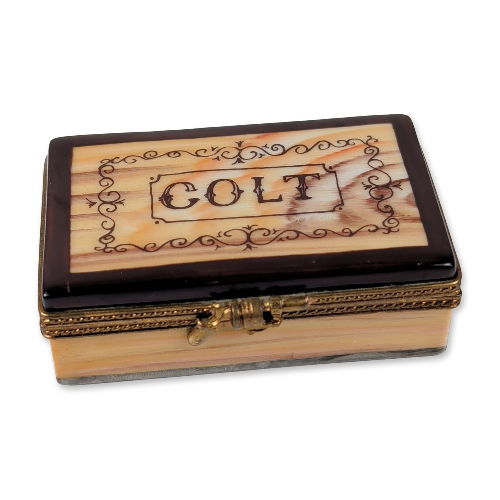 Limoges Peint Main Colt Porcelain Box: Limoges. Hand-painted porcelain trinket box in a Western Colt theme, featuring a marbled brown and tan lid decorated with the name COLT. The rectangular case includes a brass-toned metal frame and a m