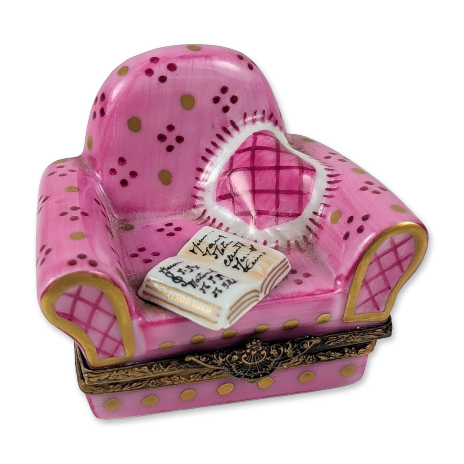 Limoges Porcelain Armchair Box: This hand-painted porcelain collectible container is sculpted in the form of a vintage wingback armchair. The exterior features a pink textured glaze embellished with gilt polka dots, gold-toned borde