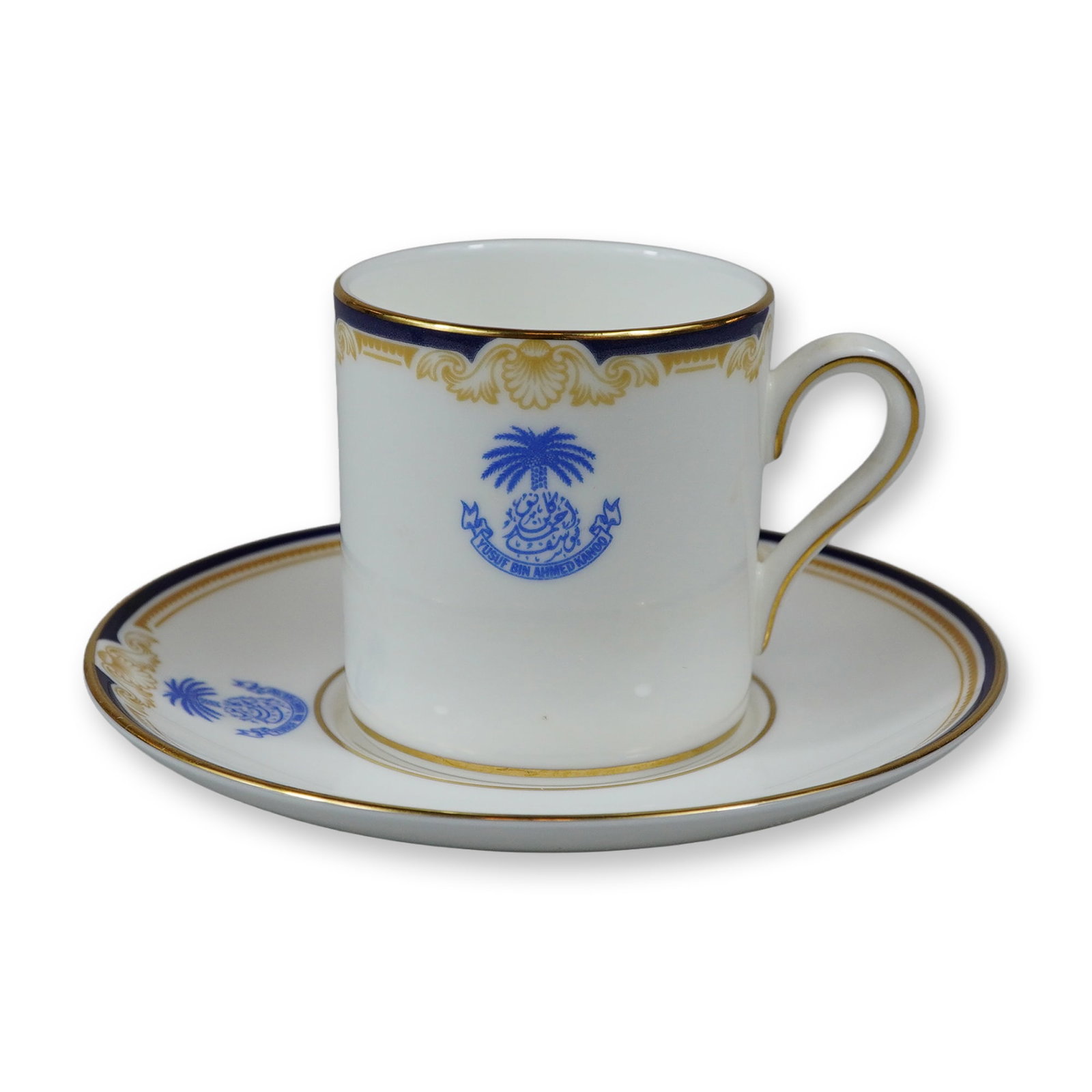 Wedgwood Bone China Demitasse Cup and Saucer, Cavendish Pattern: A Wedgwood fine bone china demitasse cup and saucer set in the Cavendish pattern, reference number R4680. Each piece is crafted with a white ground featuring a navy blue border accented by gold-tone n