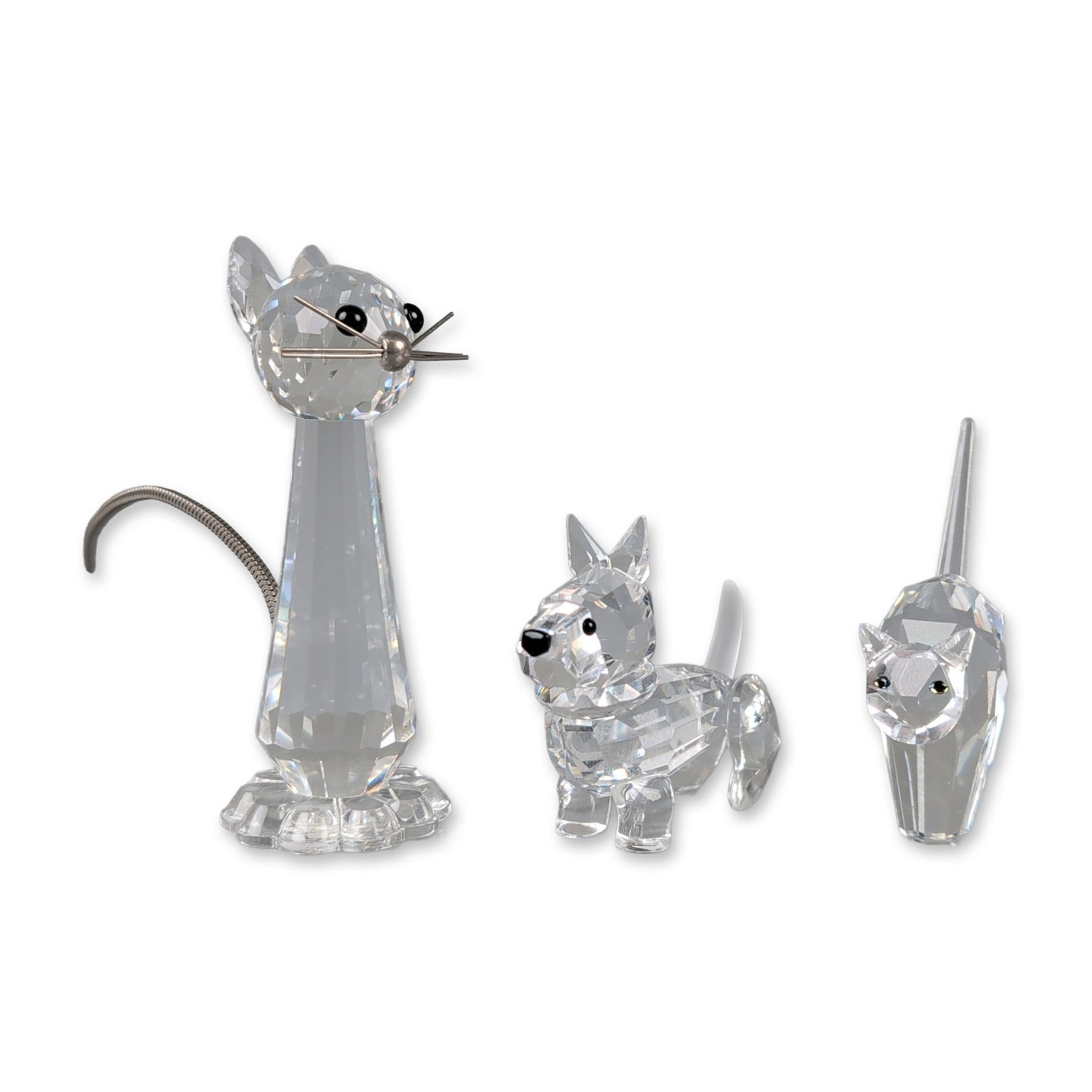 3pc Swarovski Crystal Animal Figurines: Trio of clear faceted lead crystal figurines including a tall stylized cat, a Scottish Terrier, and a small arched-back cat. The tall cat features a tapering body on a scalloped circular base, black b