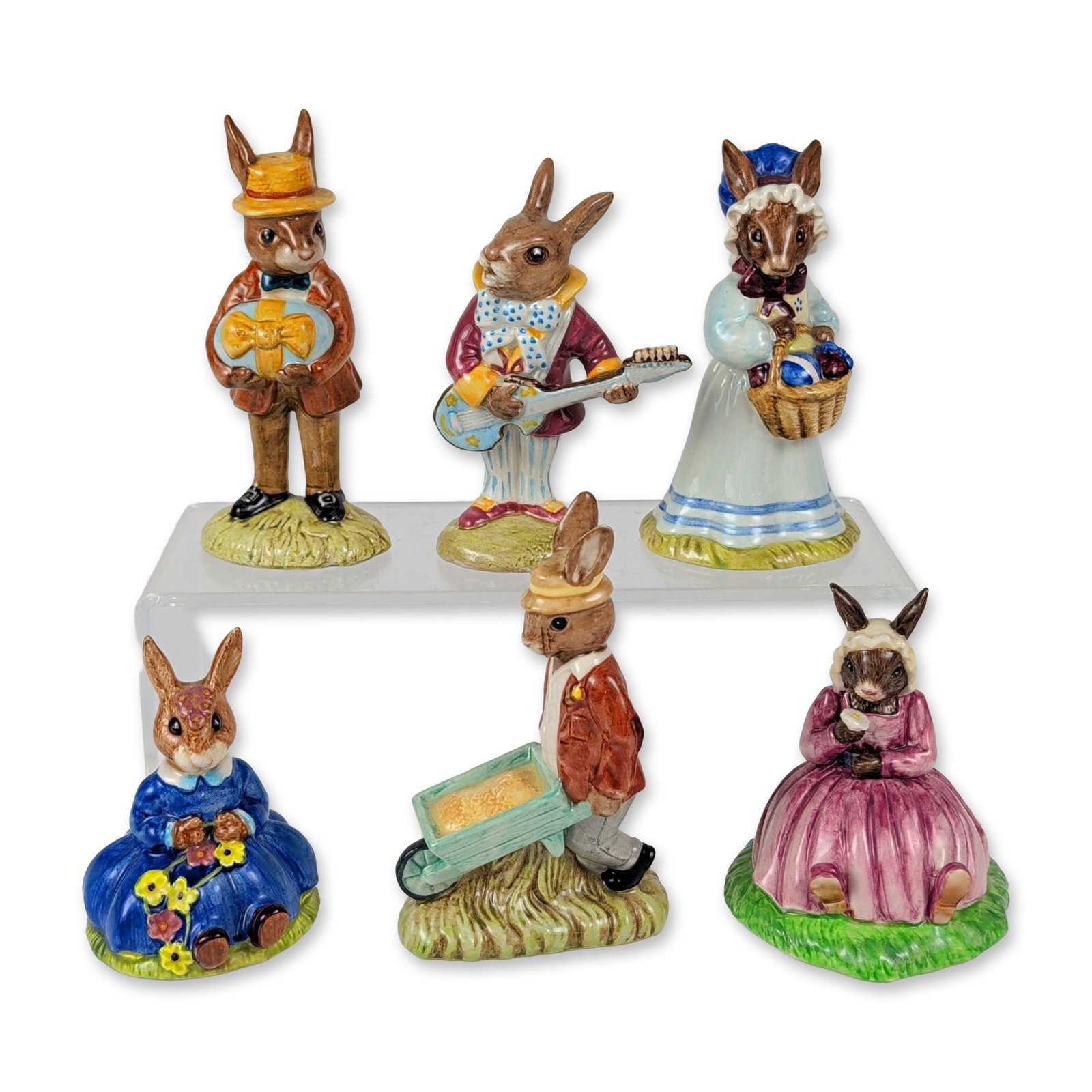 6pc Royal Doulton Springtime Garden and Celebration Bunnykins Figurine Set: This six-piece grouping of English hand-painted glazed porcelain Bunnykins figures depicts anthropomorphic rabbits in diverse costumed poses. The collection features Daisie Bunnykins Springtime DB 7 i