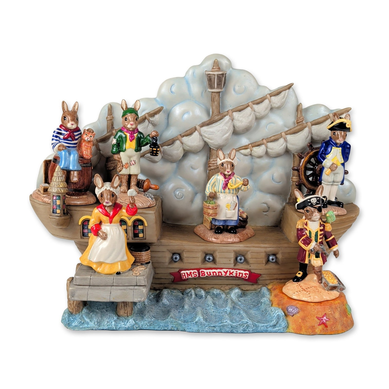 7pc Royal Doulton Bunnykins Shipmates Collection and Display Base: This nautical-themed collection and matching display base from the Royal Doulton Bunnykins line features hand-painted earthenware rabbit characters from The Shipmates Collection. The grouping consists