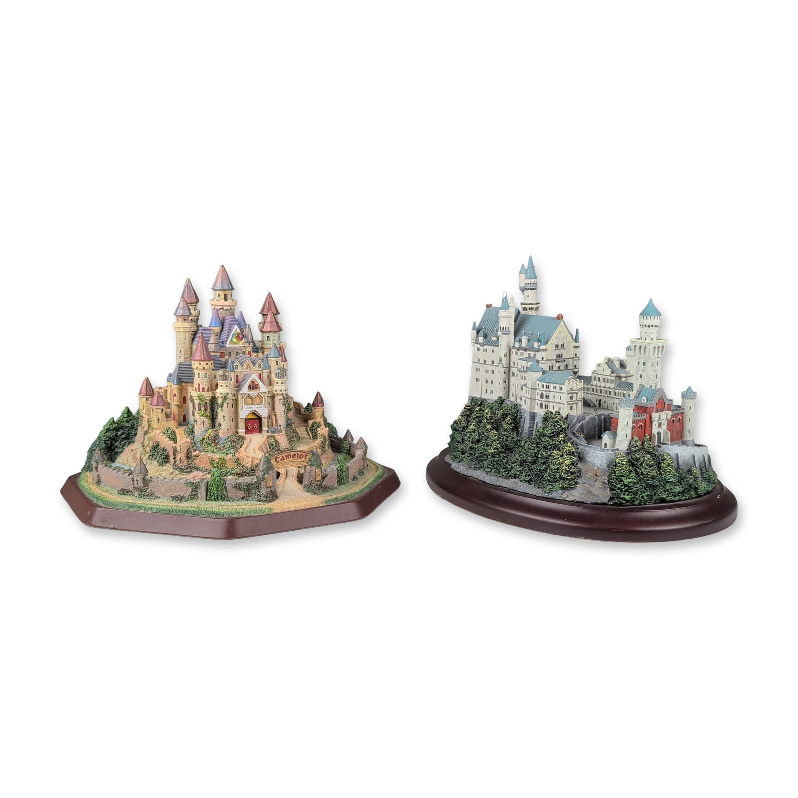 2pc Lenox Camelot and Neuschwanstein Castle Figurines: Lenox. Pair of architectural miniature figurines in hand-painted resin, depicting the legendary Camelot and the historical Neuschwanstein Castle. The Camelot model features tan textured masonry and to