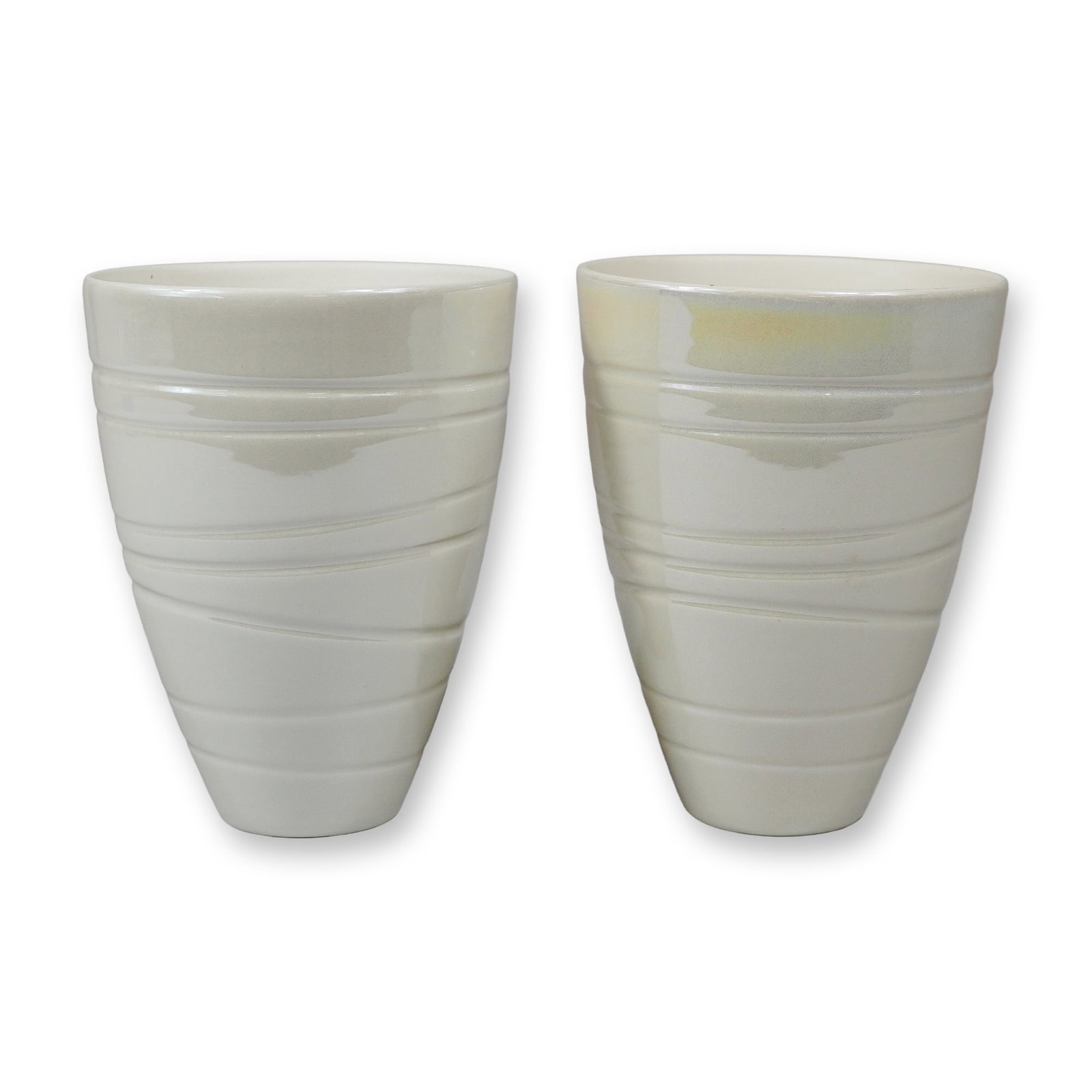 A Pair of Jasper Conran for Wedgwood White Glazed Spiral Beakers: This lot features a pair of white glazed ceramic beakers produced as part of the collaboration between designer Jasper Conran and the Wedgwood pottery. Each piece is designed in a tapered conical form