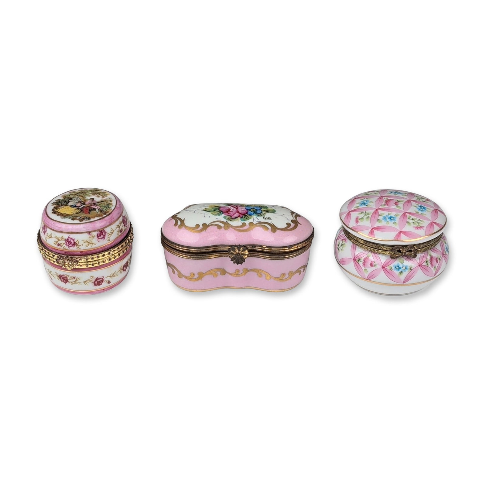 3pc Porcelain and Gilt Metal Trinket Boxes: A trio of porcelain trinket boxes with hinged gilt metal mounts. The group includes a Gouleville Limoges France oblong box with a lobed waist, featuring a central white reserve with a hand-painted flo