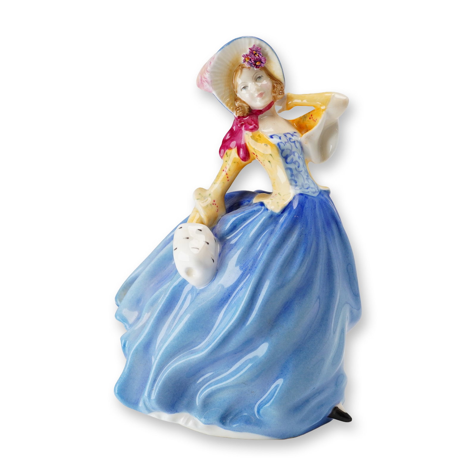 Royal Doulton Bone China Figurine, Autumn Breezes HN3736: Part of the Michael Doulton Events series. Designed by Leslie Harradine. Hand-painted figurine depicting a woman in a flowing baby blue dress with a coordinating light and dark blue patterned bodice. 