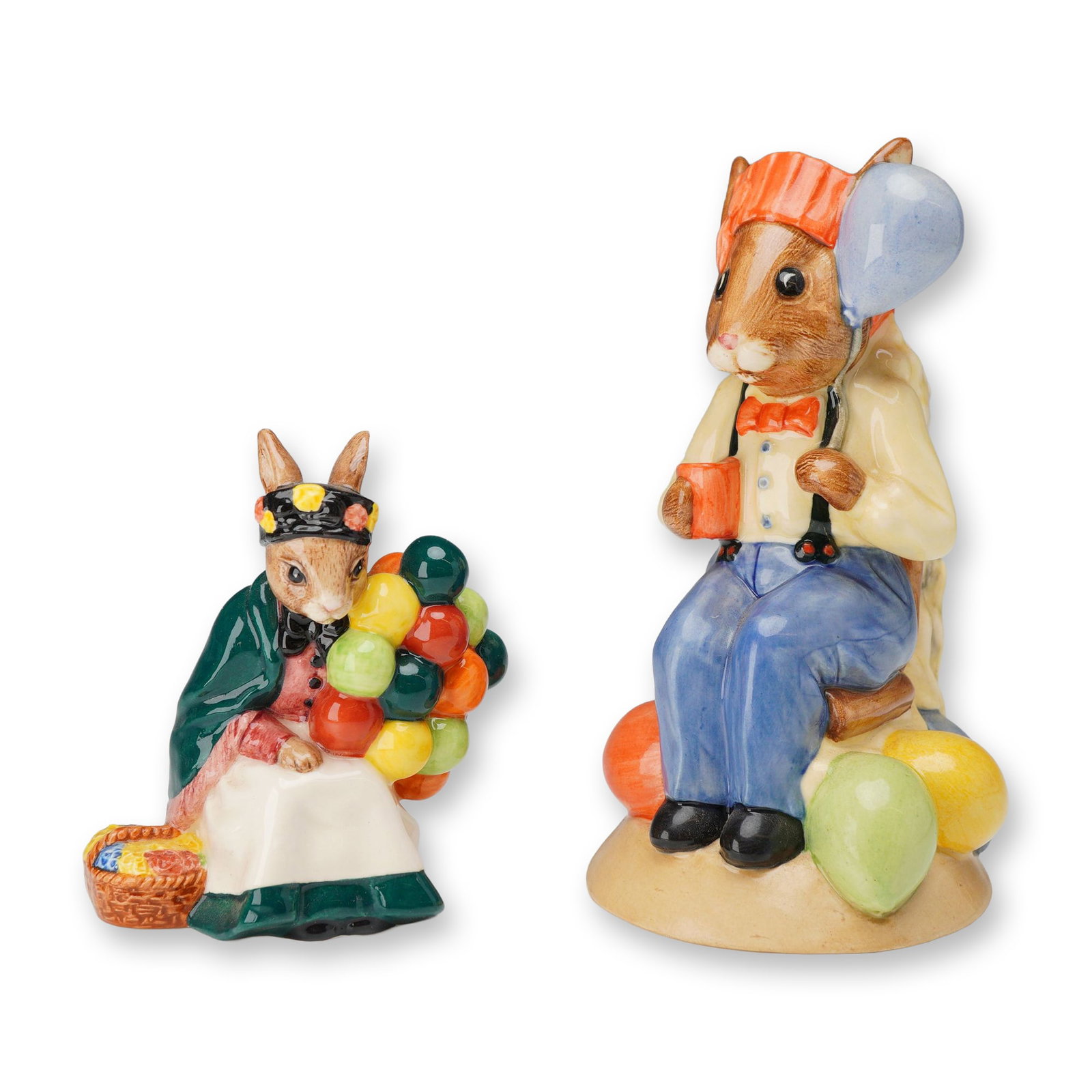 2pc Royal Doulton Bunnykins Figure and Toby Jug, Balloon Seller and Party-Time Bunnykins: Two Royal Doulton Bunnykins glazed ceramic figures. The first is Old Balloon Seller Bunnykins, model DB 217, depicting a seated female rabbit in a green shawl and black bonnet holding a cluster of col