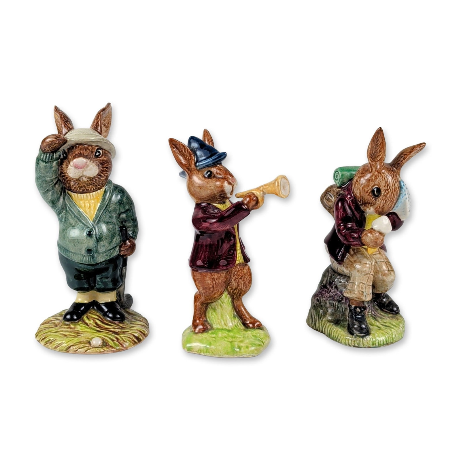 3pc Royal Doulton Ceramic Bunnykins Figurines: 3pc Royal Doulton hand-painted glazed ceramic figurines from the Bunnykins series. The collection features three distinct models: Cooling Off (DB3), depicting a hiking rabbit in a maroon jacket with a