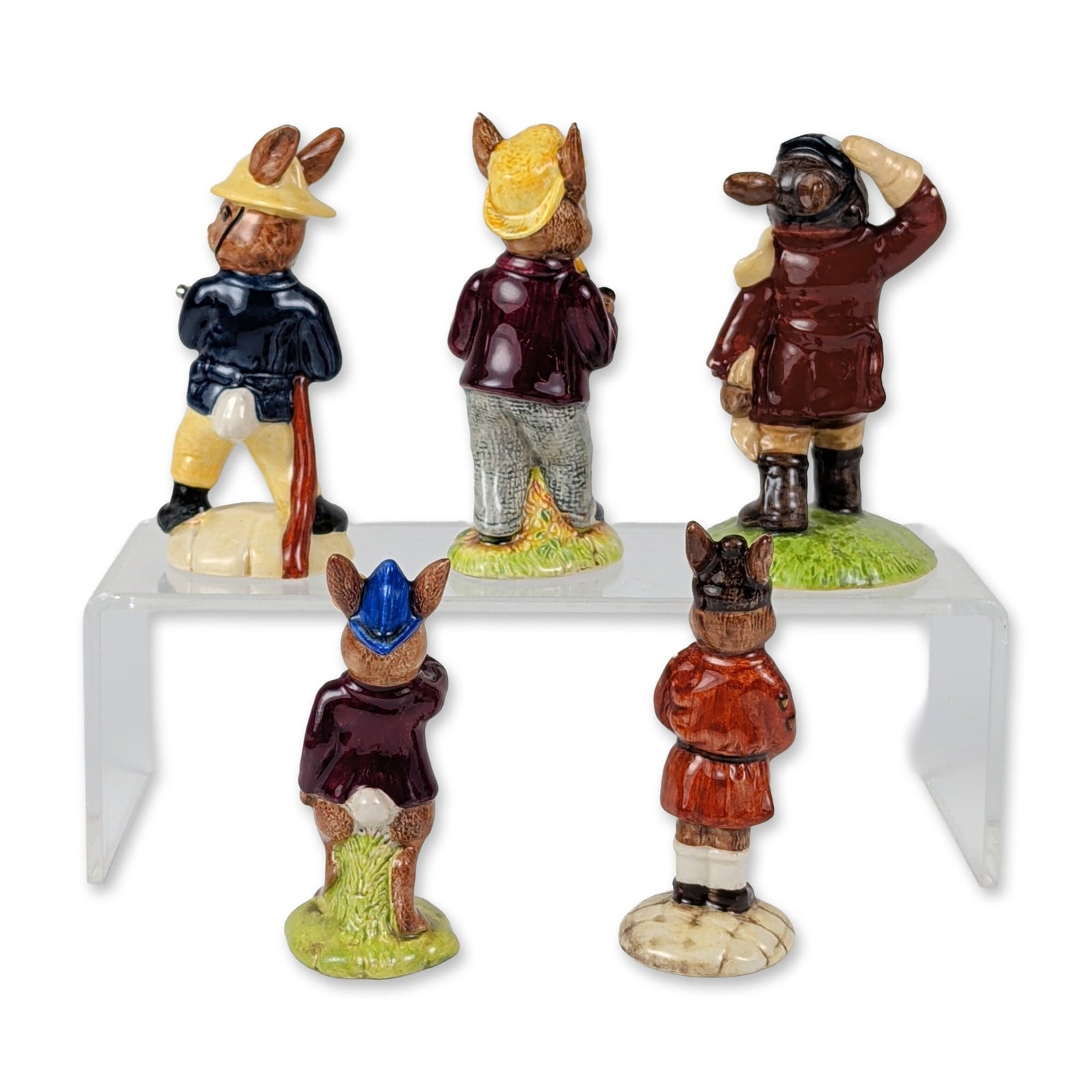 5pc Royal Doulton Service and Seasonal Bunnykins Figurines: This five-piece collection of glazed ceramic figurines from the Royal Doulton Bunnykins line features anthropomorphic rabbit characters in varied service and seasonal roles. The grouping consists of F