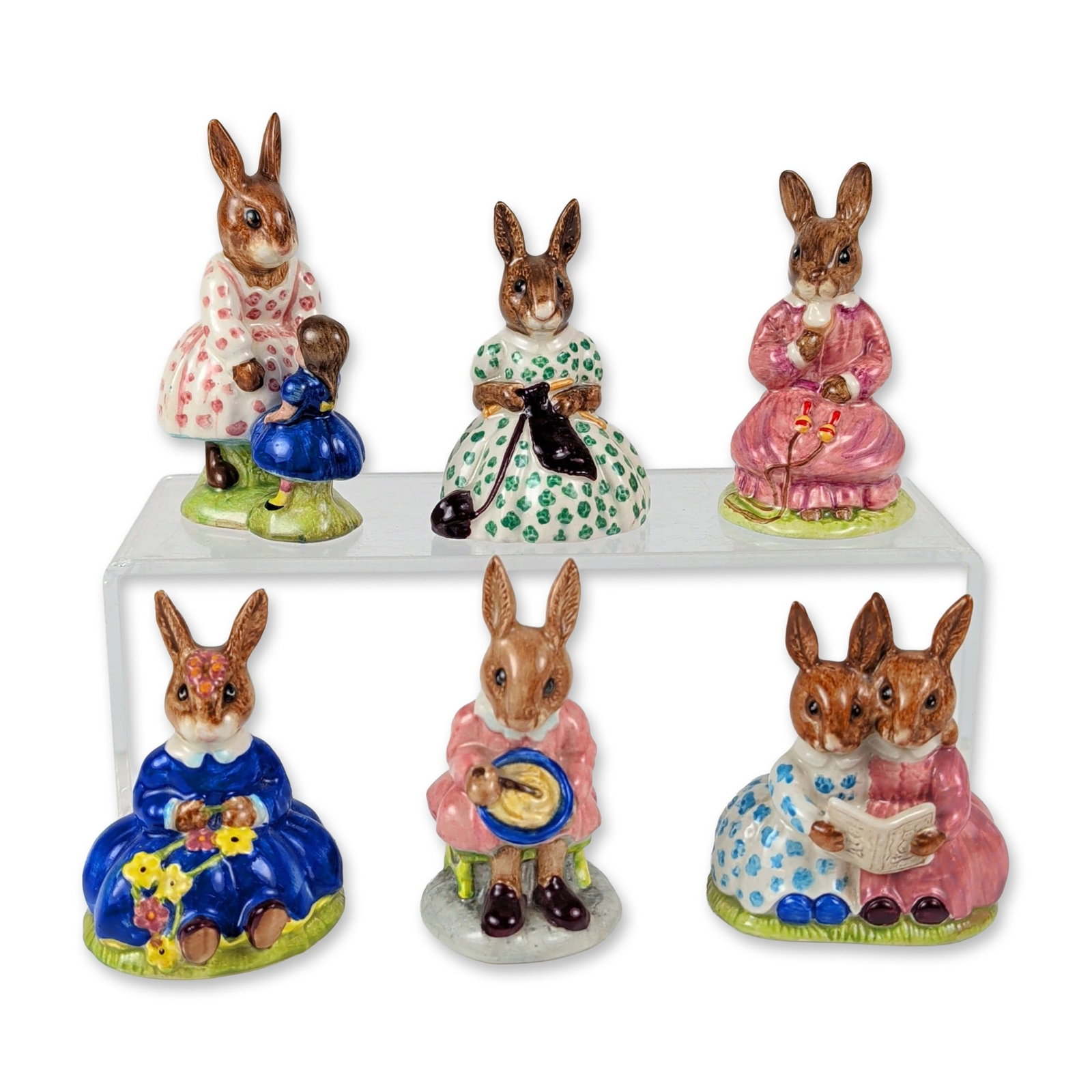 6pc Royal Doulton Bunnykins Figurines: This six-piece collection of English hand-painted glazed ceramic Bunnykins figures highlights anthropomorphic rabbits in various active, playful, and household scenes. The grouping features Polly DB 7