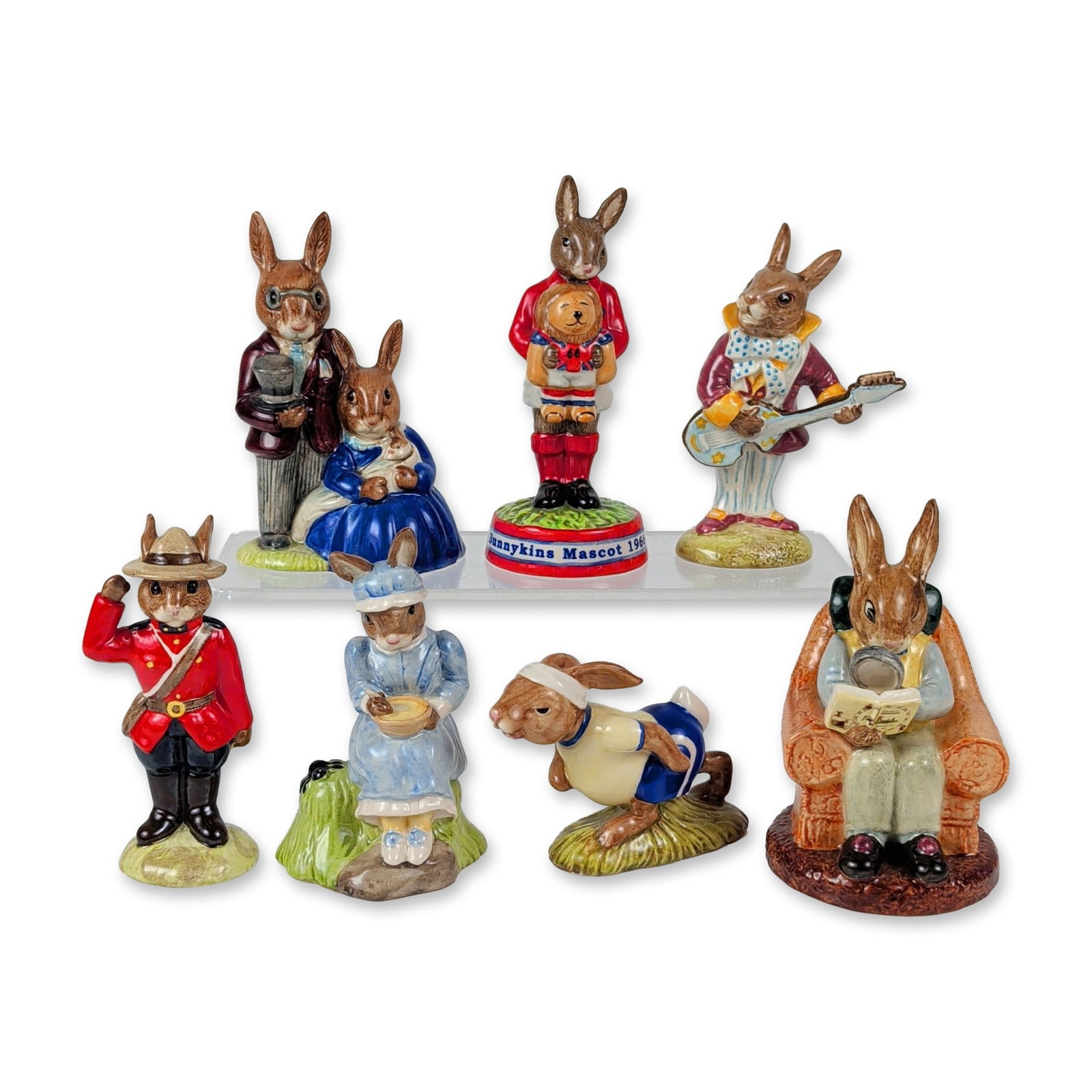 7pc Royal Doulton Bunnykins Figurines: This seven-piece collection of glazed polychrome ceramic figurines from the Royal Doulton Bunnykins line features a diverse assortment of character and theme-based rabbits. The grouping consists of Mr