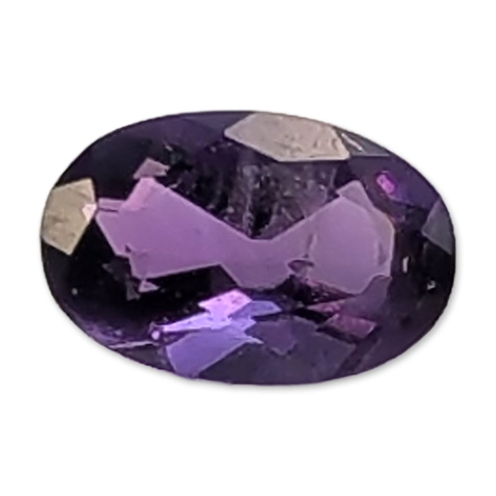 Oval Cut Purple Amethyst Loose Gemstone: Loose faceted amethyst gemstone . The stone exhibits a deep violet-purple hue with secondary magenta flashes throughout. It is presented in an oval faceted cut with symmetrical proportions. The