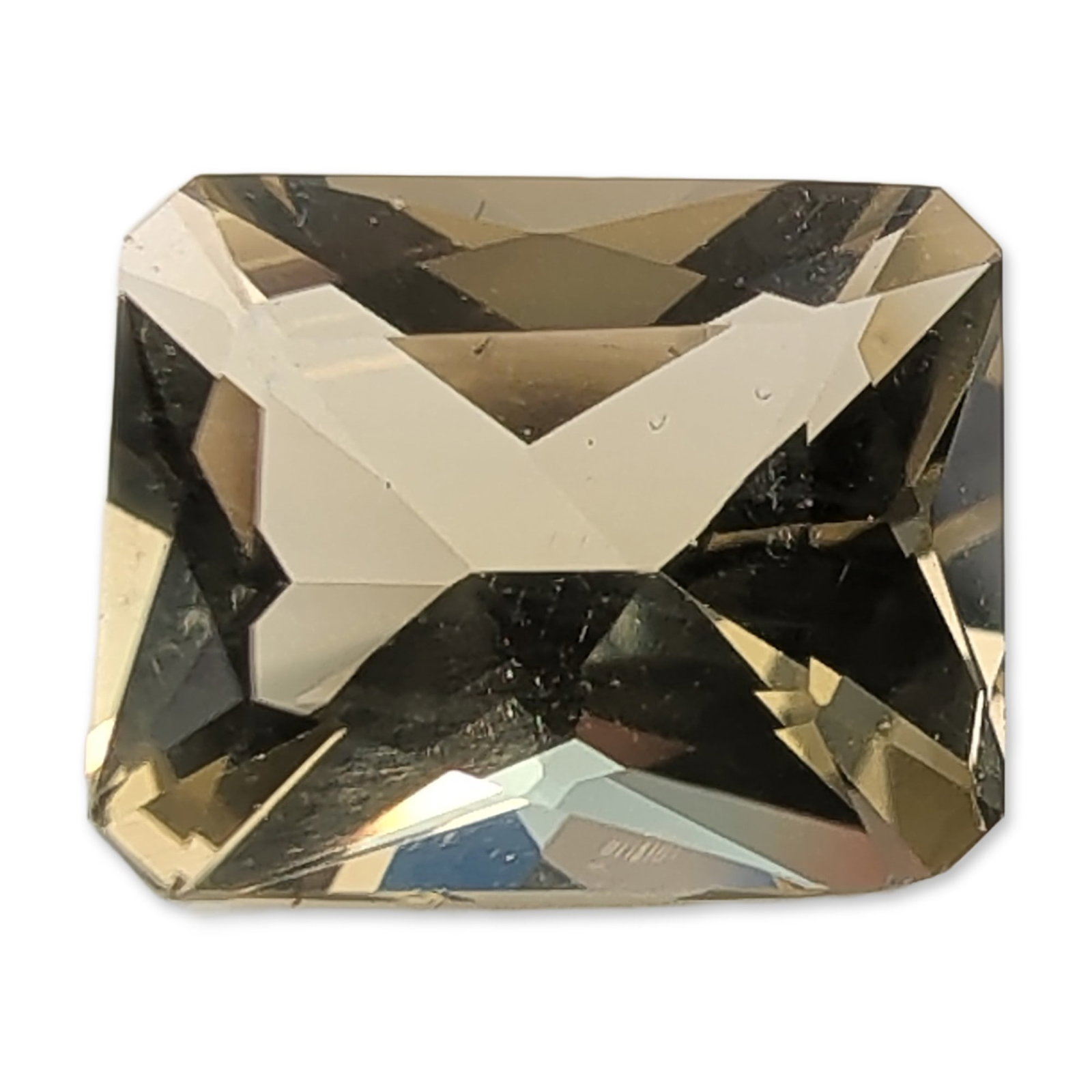 Radiant Cut Champagne Quartz Gemstone: Loose faceted quartz gemstone in a light champagne or smoky hue. The stone features a rectangular radiant-style cut with clipped corners. The gemstone displays high transparency and is eye-clean with 