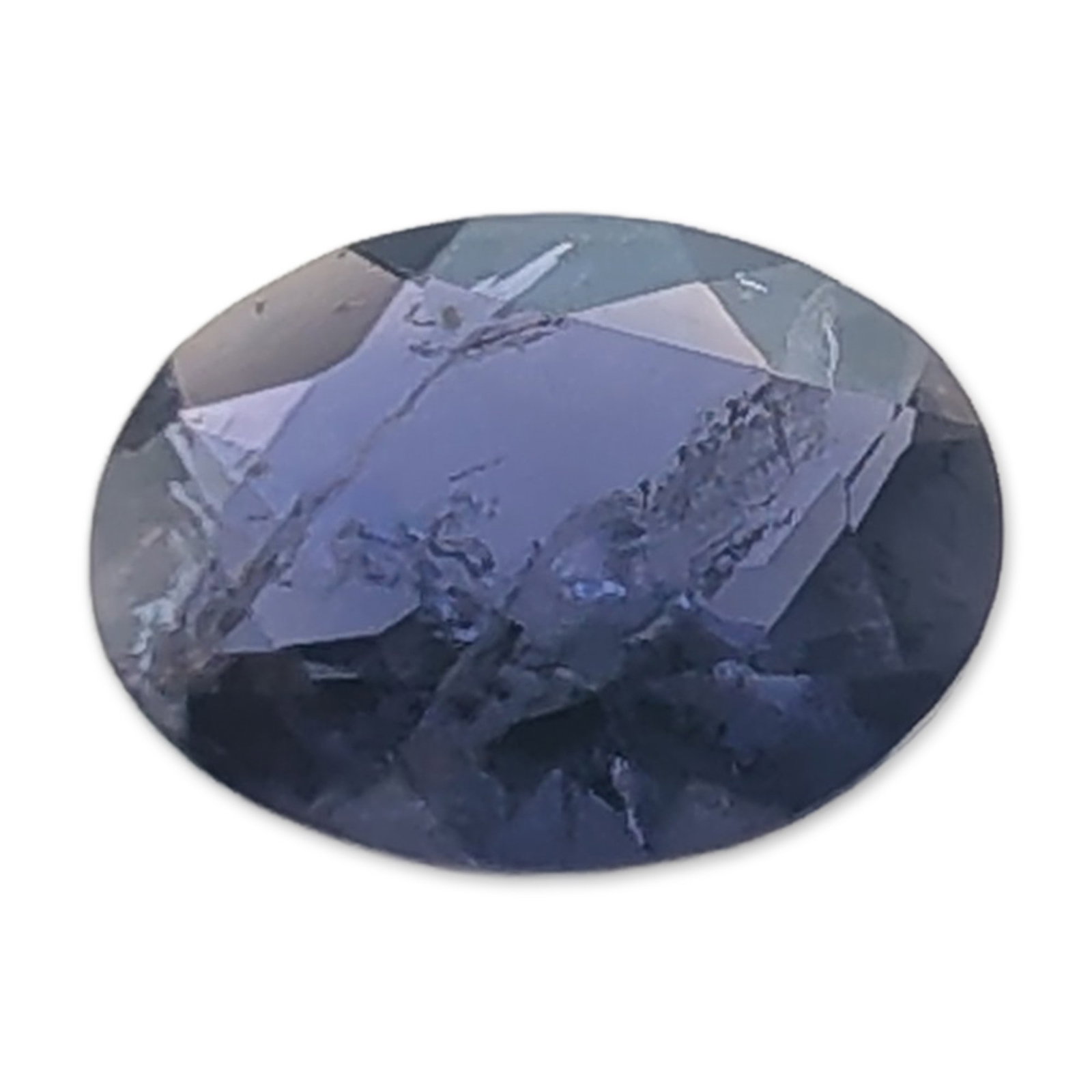 Oval Cut Natural Iolite Gemstone: A loose oval-cut faceted iolite gemstone of deep blue-violet hue. The stone features significant internal inclusions, fractures, and veining visible through the facets. Tested with Presidium Gem