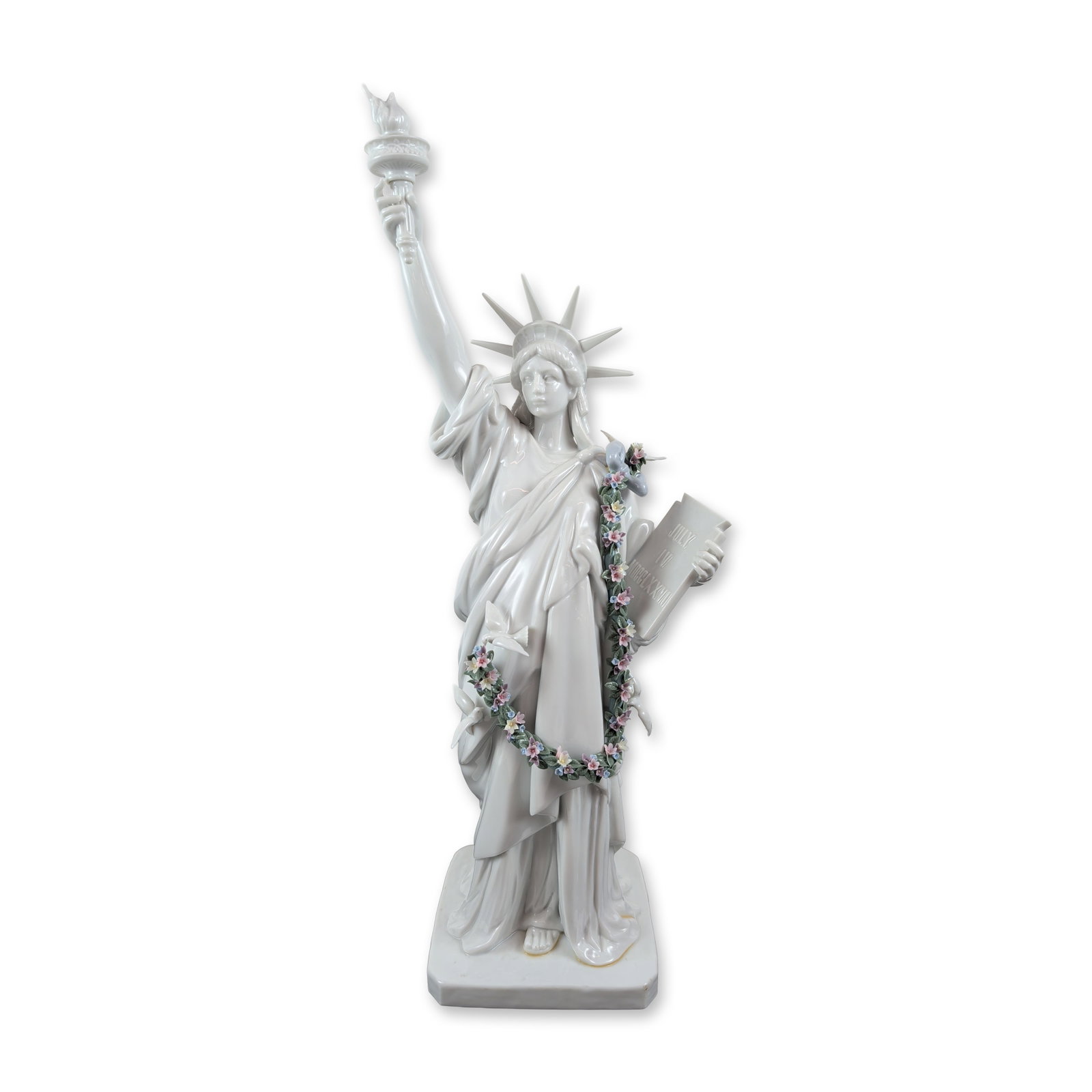 Lladro Spanish Glazed Porcelain Statue of Liberty Figurine: Lladro (Spain). Glazed porcelain figurine Statue of Liberty, model number 7563, featuring a hand-applied floral garland and ribbon. The underside bears the blue underglaze maker mark and hand-signed s