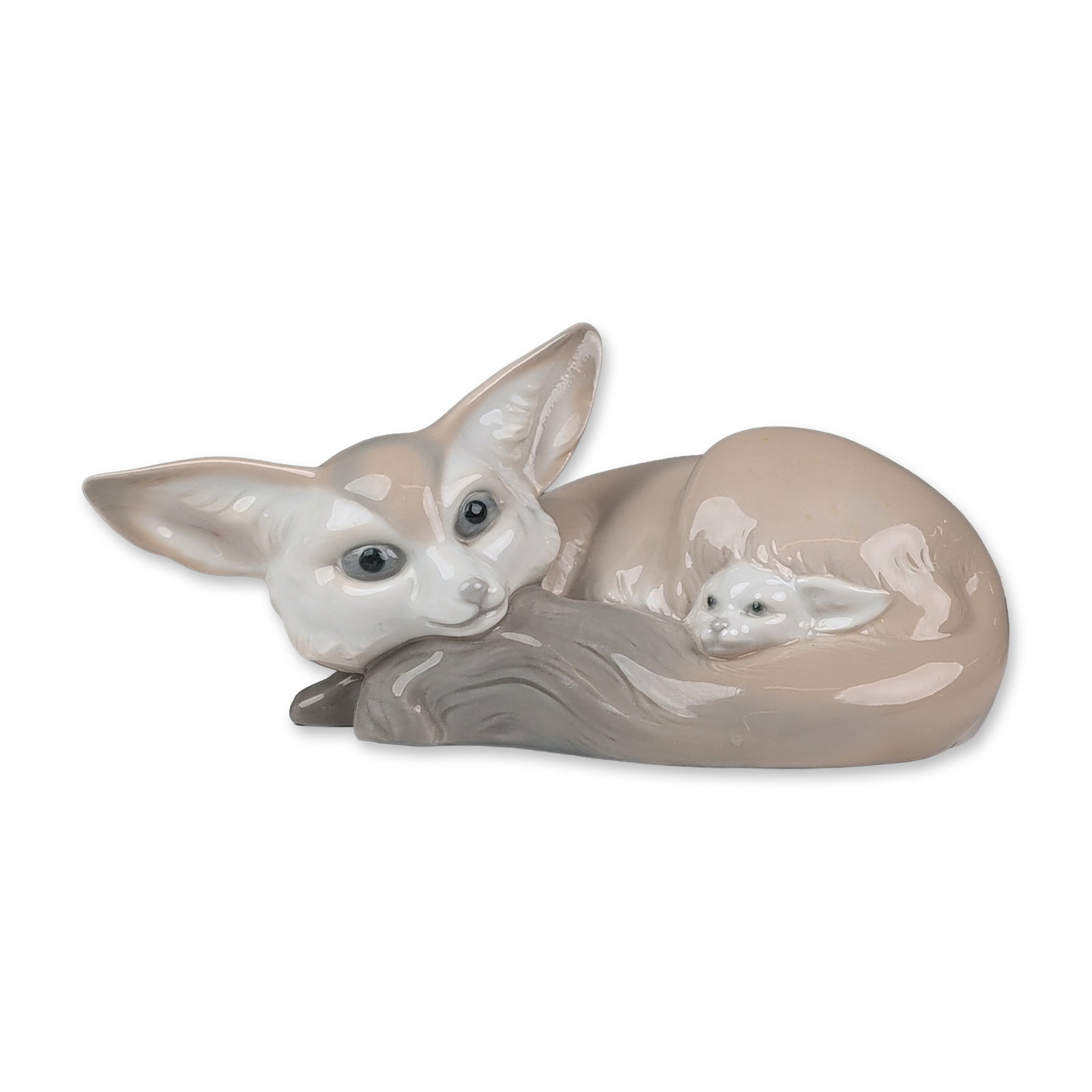 Lladro Porcelain Figurine, Fox and Cub 01001065: Lladro, Spain. Porcelain figurine in glazed finish, depicting a mother fennec fox curled around her kit with prominent ears and a muted palette of beige, grey, and white. The base features a printed b