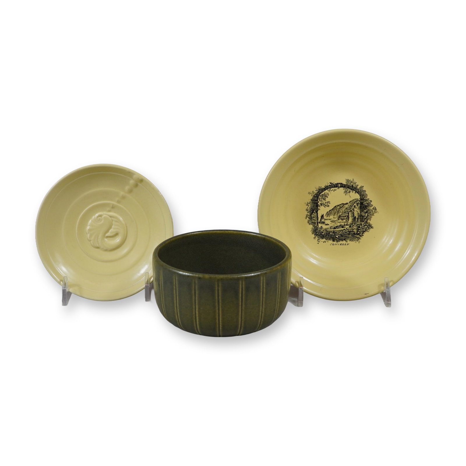 3pc Wedgwood Items Including Rex Whistler Clovelly Bowl, Cambrian Green Bowl, and Nautilus Shell: This lot consists of three ceramic items manufactured by Wedgwood. The first is a shallow earthenware bowl finished in a Matt Straw glaze, featuring a black transfer-printed landscape titled Clovelly.