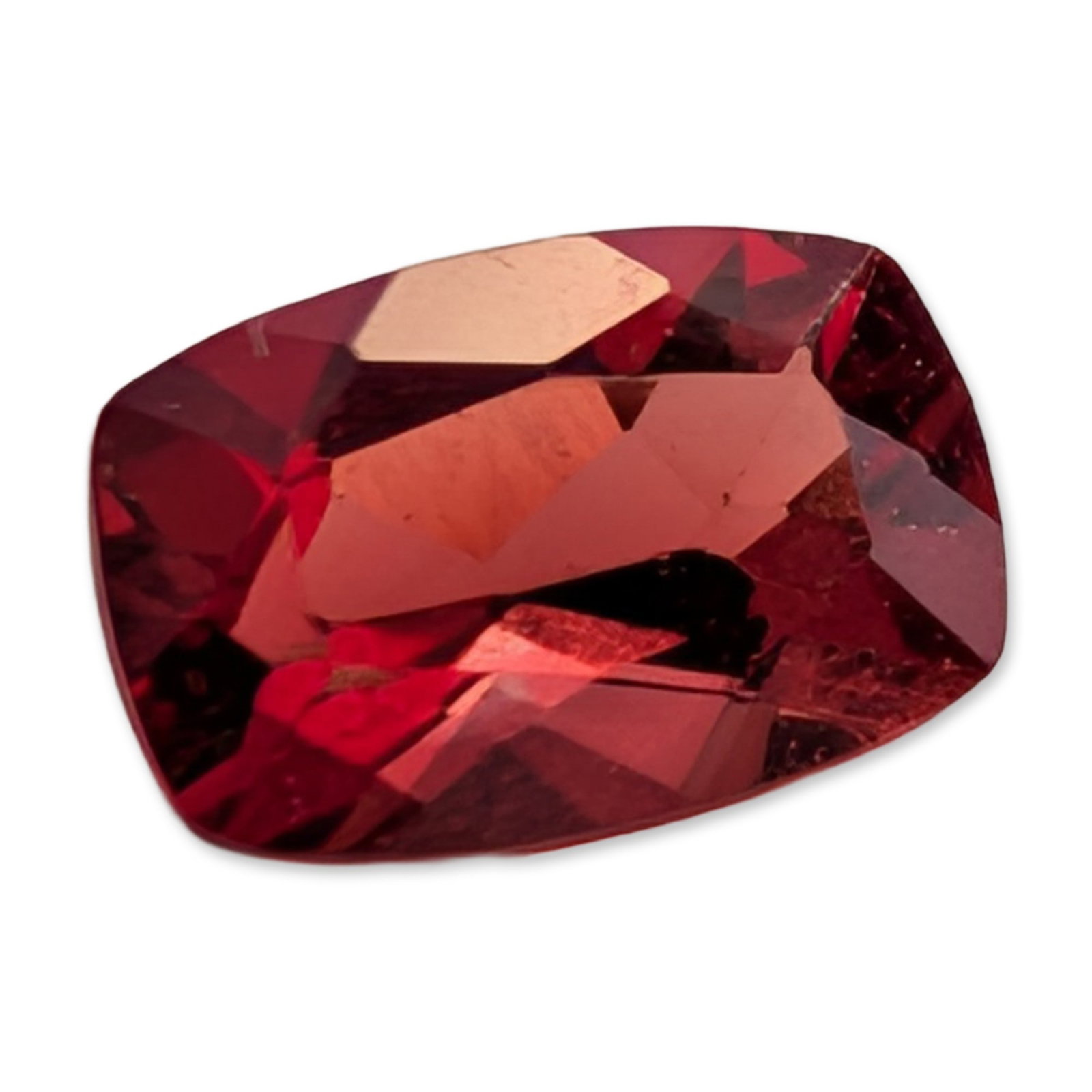 Modified Cushion Cut Red Gemstone: Modified cushion cut loose gemstone. Faceted stone in a deep red hue with pinkish undertones. Material appears to be a variety of spinel, garnet, or tourmaline. The piece is faceted with a crown and p