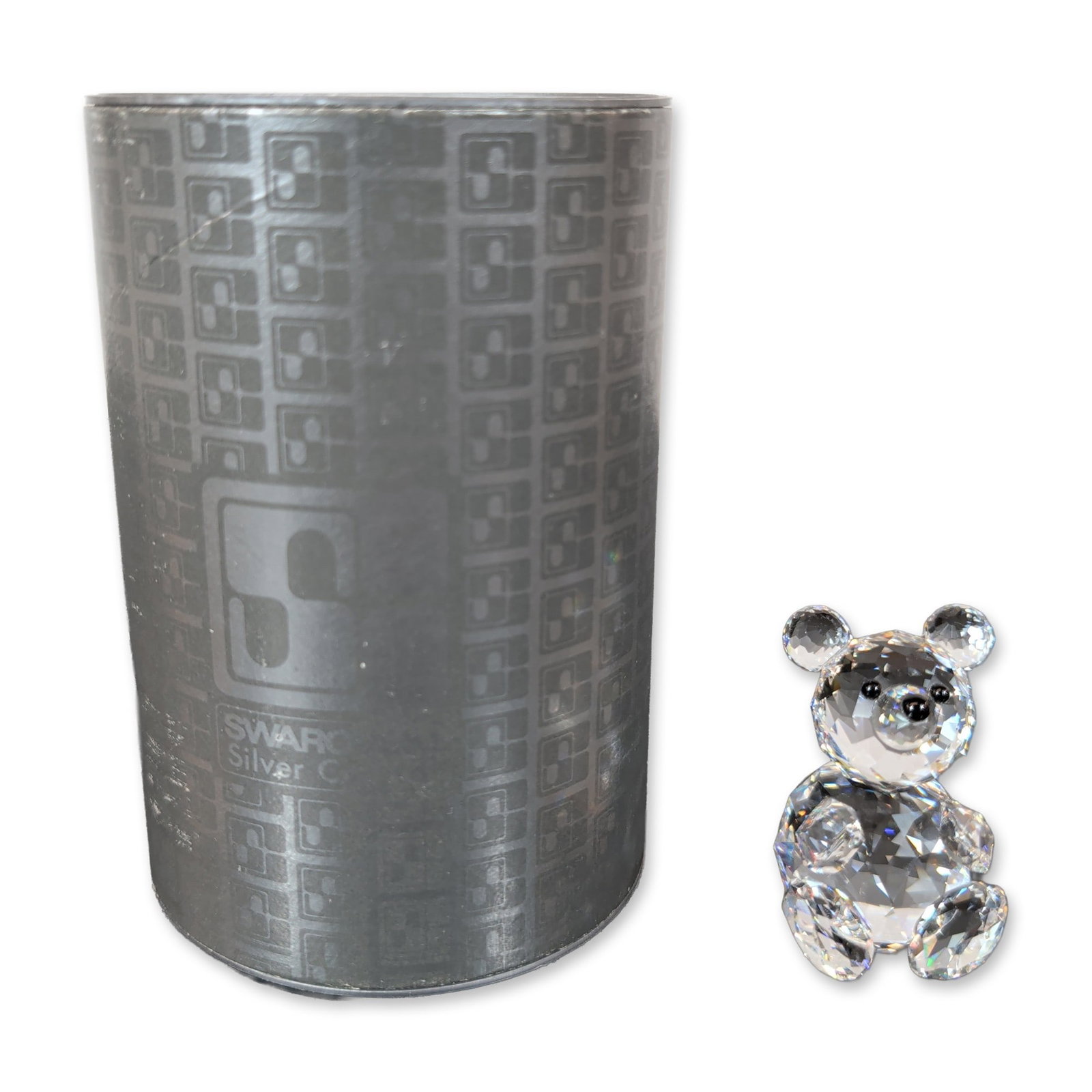 Swarovski Silver Crystal Teddy Bear Figurine: The seated figure features three small black crystal accents representing the eyes and nose. The underside of the piece is marked with the laser-etched block Swarovski "S" logo and the company name. A
