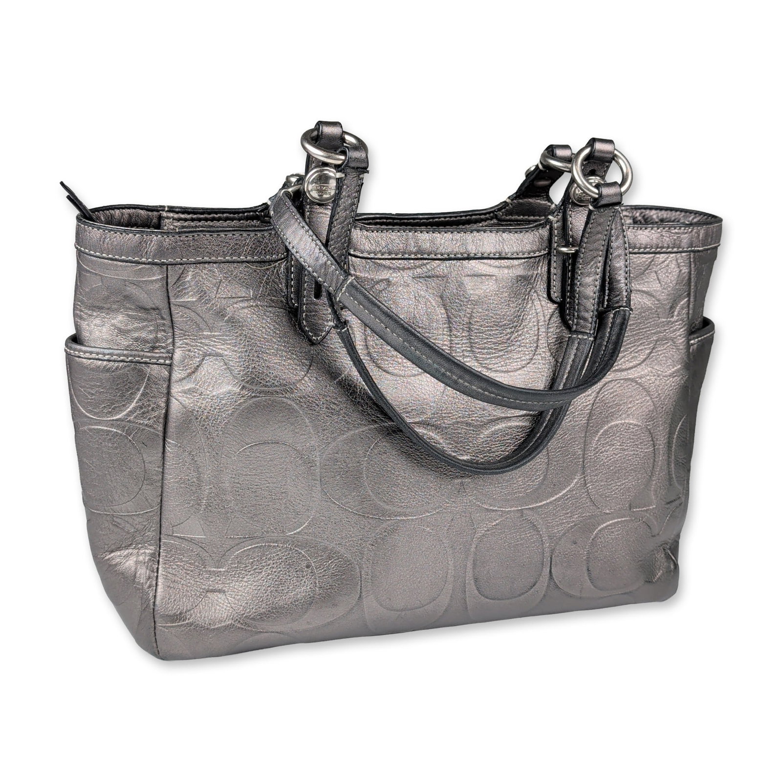 Coach Metallic Signature Leather Purse: A Coach purse in gunmetal metallic embossed signature leather. The exterior features an all-over embossed signature C pattern, dual flat leather shoulder straps with silver-tone nickel ring accents, t