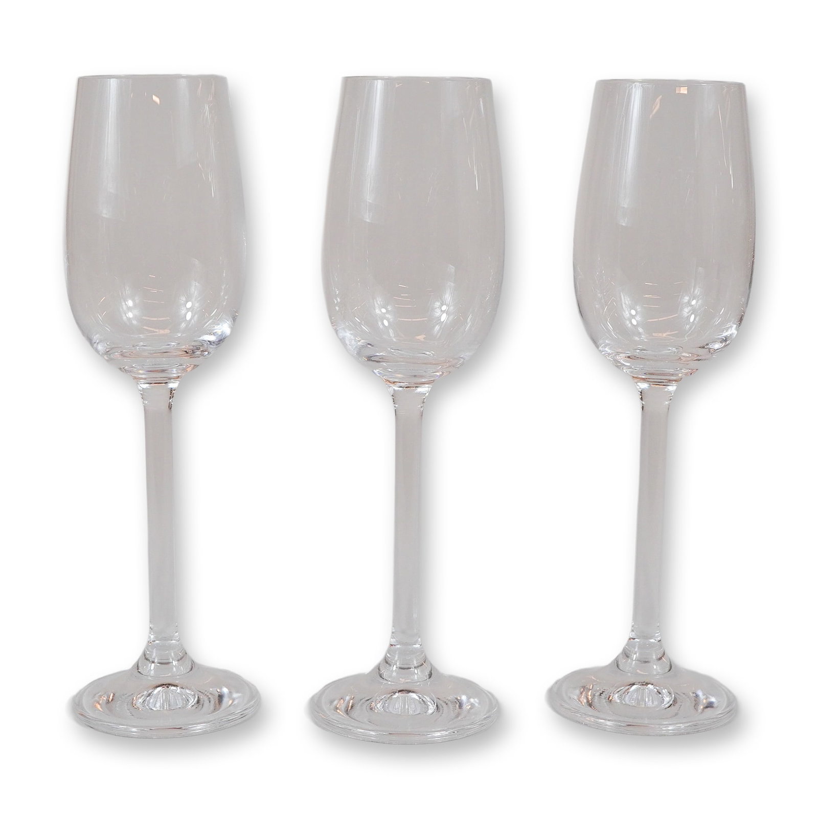 3pc Contemporary Clear Glass Champagne Flutes: A set of three matching contemporary clear glass stemware pieces, designed as champagne flutes. Each piece features a tall, narrow tulip-form bowl that tapers slightly toward the rim, supported by a