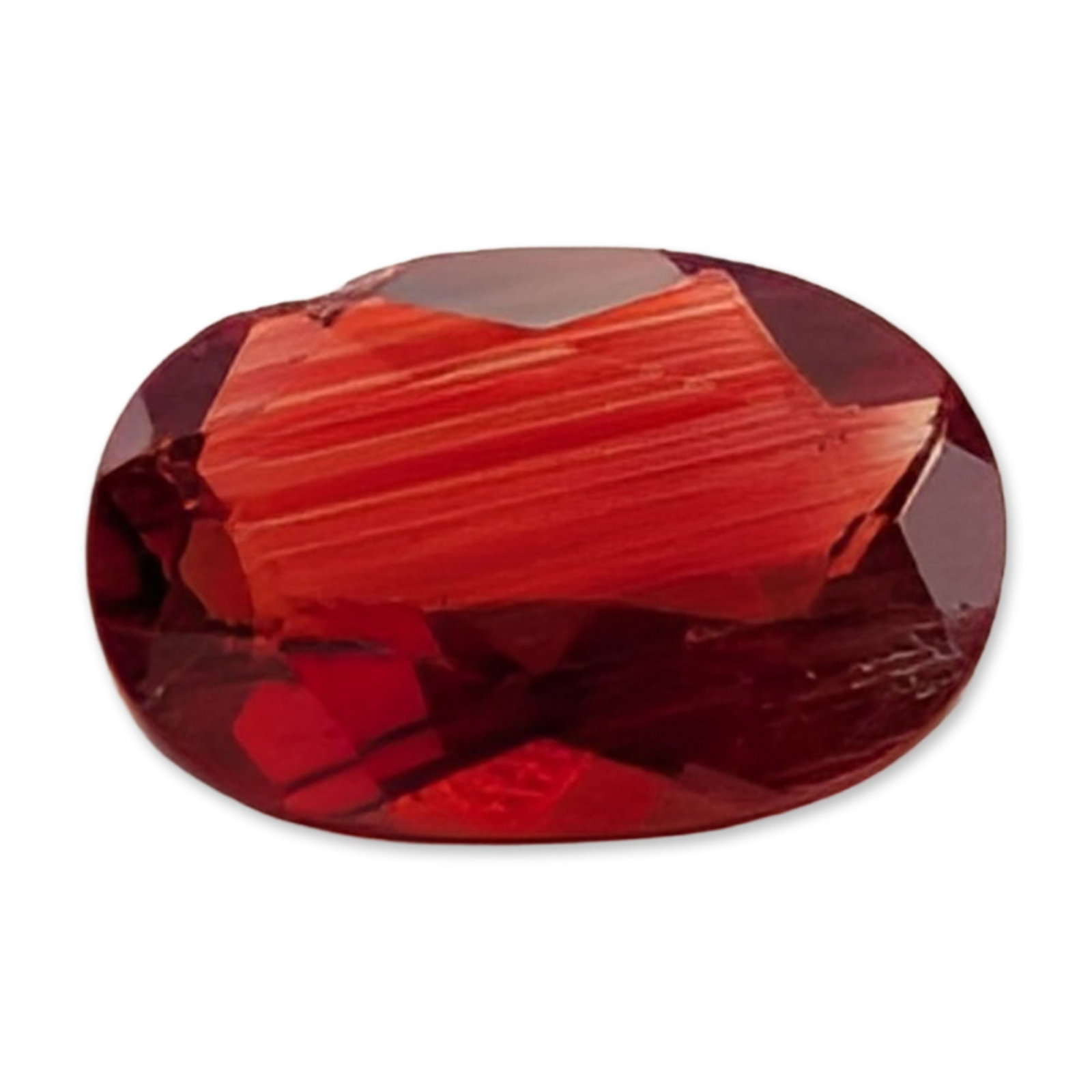Oval Mixed Cut Red Stone: Loose stone, featuring a saturated red hue and is fashioned in an oval mixed cut. The interior exhibits prominent, closely spaced parallel growth lines or striations visible through the table facet. 0