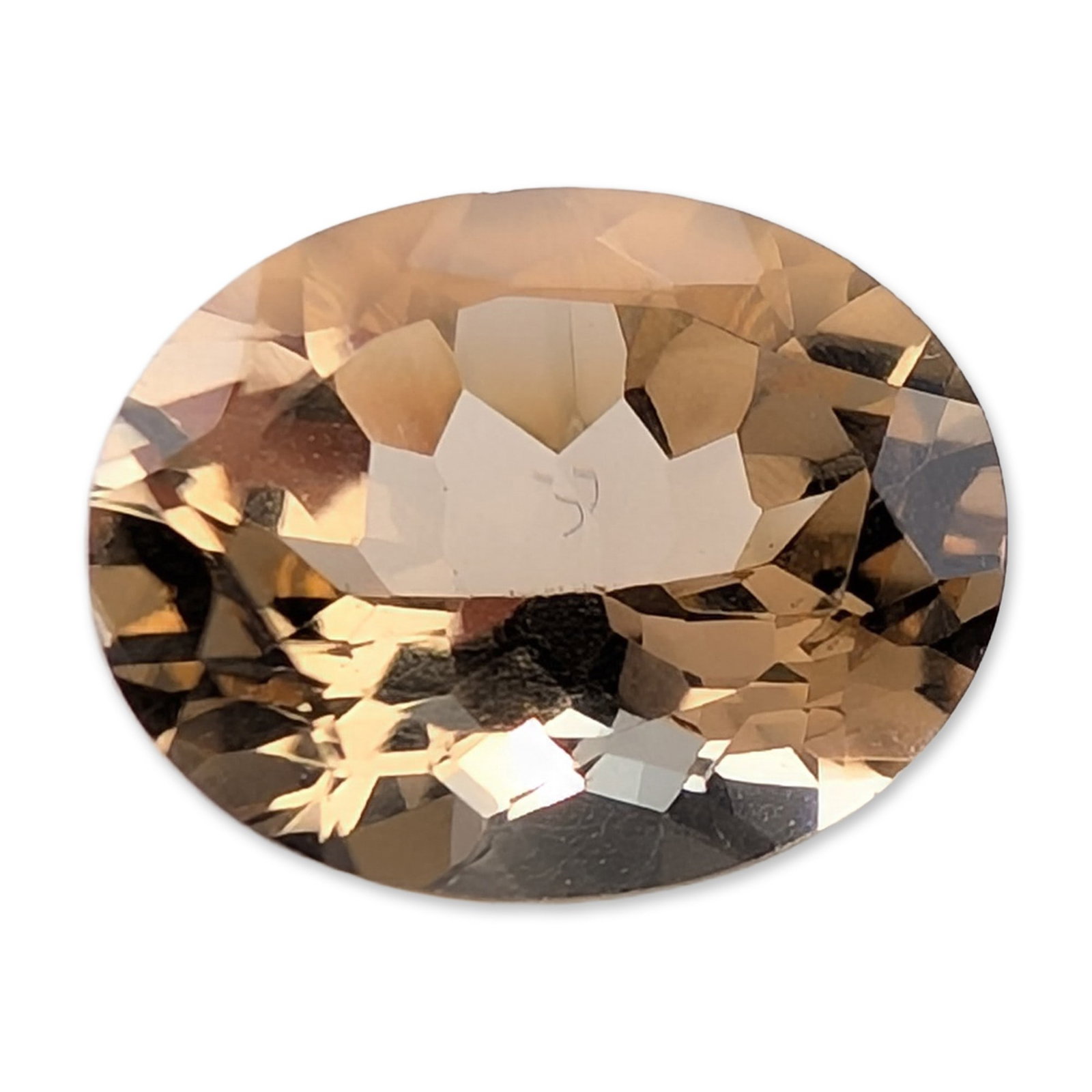 Faceted Oval Mixed Cut Champagne Peach Quartz Gemstone: Loose faceted gemstone featuring an oval mixed cut with a faceted crown and pavilion. Color is a light peachy-brown or champagne hue with high transparency and eye-clean clarity. The faceting