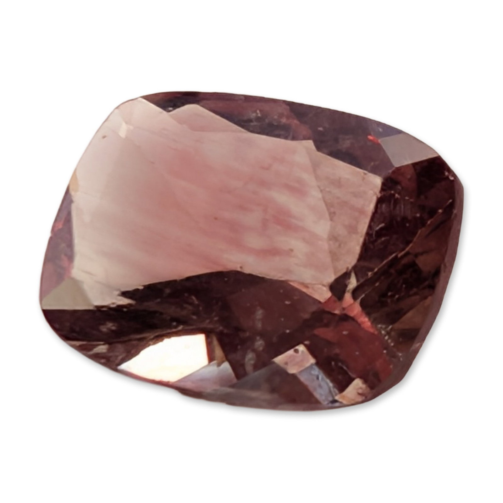 Natural Cushion Cut Brownish Pink Stone: Loose faceted stone featuring a rectangular cushion cut. The stone exhibits a saturated brownish-pink to reddish-orange color with a sleepy internal appearance caused by dense, fine silky inclusions