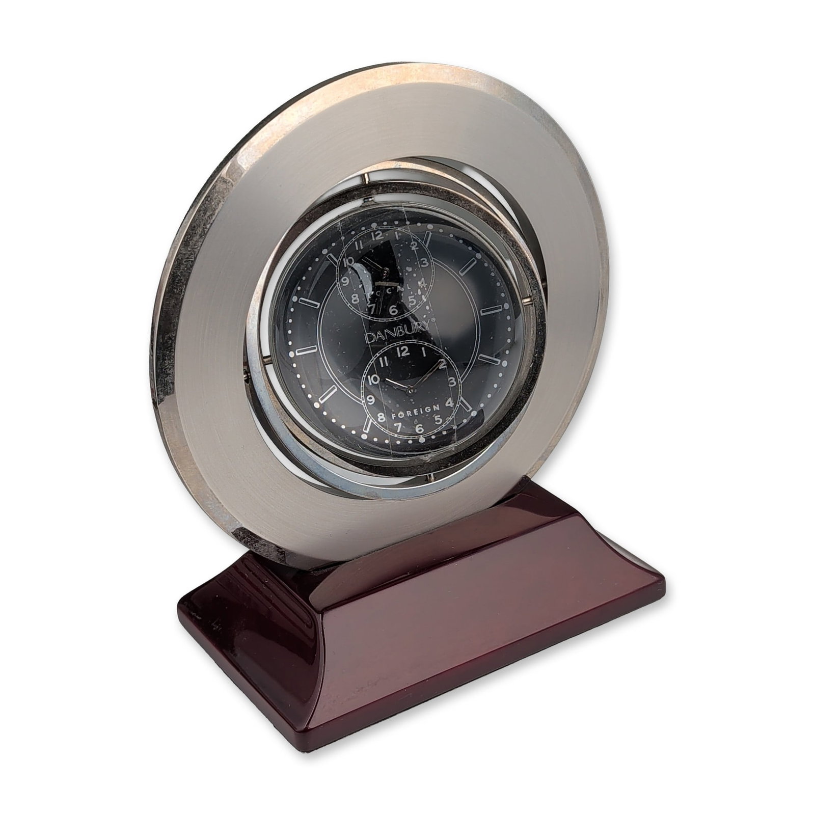 Danbury Silver-Tone Gimbal Desk Clock with Globe: Danbury gimbal desk clock in silver-tone metal and glass, featuring a dual-axis rotating frame and a high-gloss burgundy-finished base. The assembly incorporates a dual-face design with a quartz clock