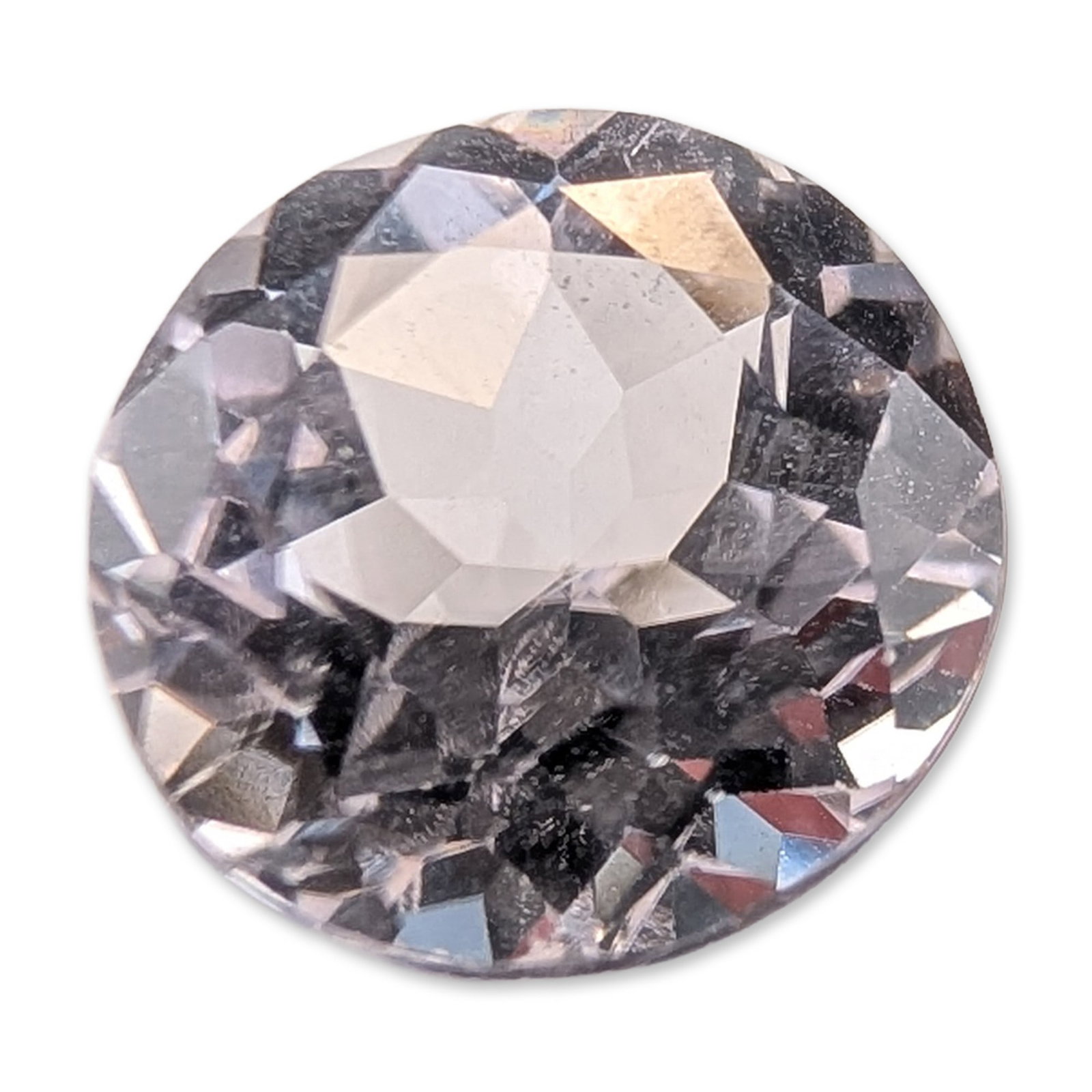 Round Brilliant Cut Near-Colorless Loose Quartz Gemstone: Round brilliant style. Faceted quartz gemstone in what appears to be a near-colorless mineral, featuring a circular girdle, crown with flat table, and pointed pavilion. The stone exhibits subtle