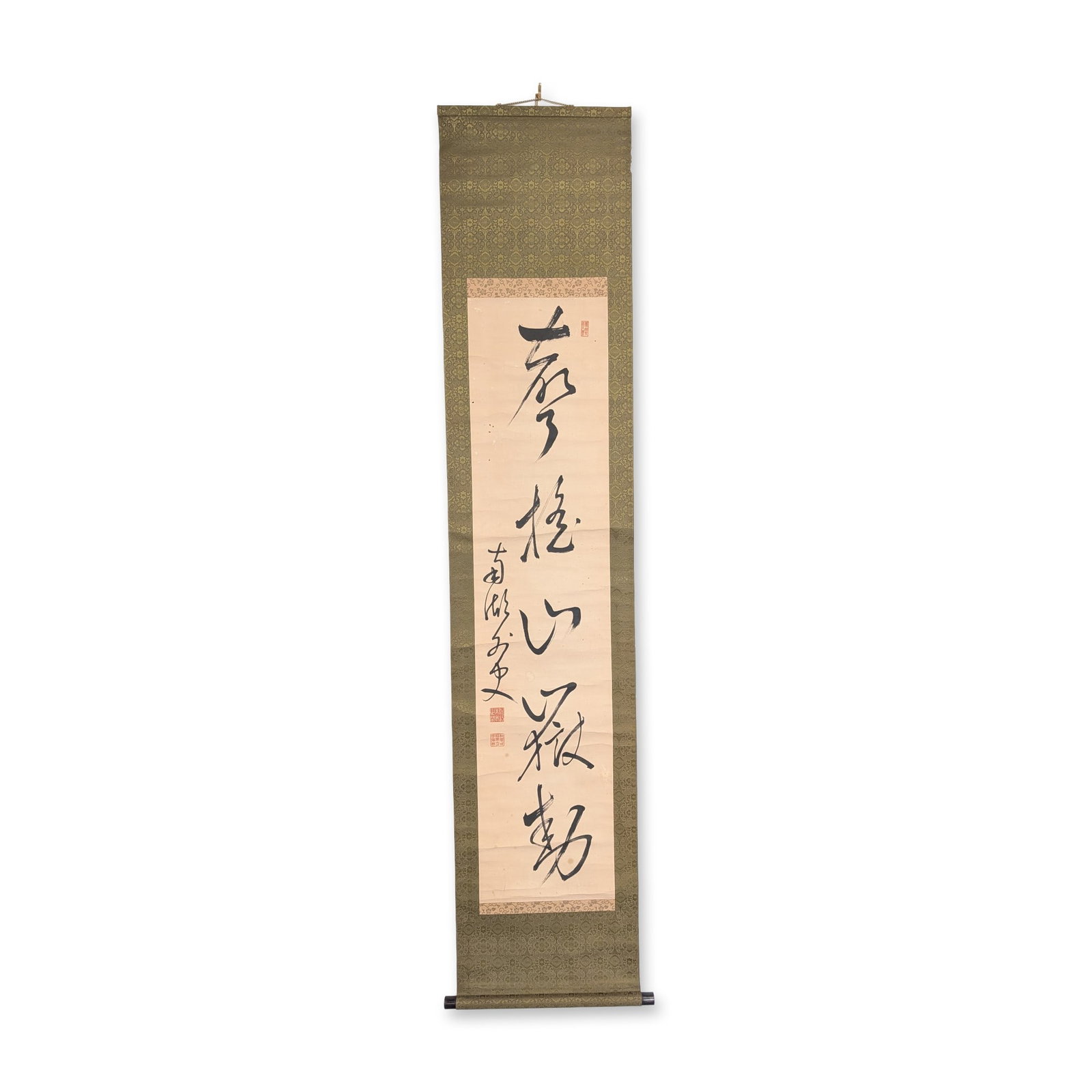 Japanese Ink on Paper Calligraphy Kakejiku Hanging Scroll: Japanese kakejiku hanging scroll in ink on paper, featuring a vertical composition of characters in cursive script. The paper panel is mounted on a floral-patterned silk brocade with two strips at the