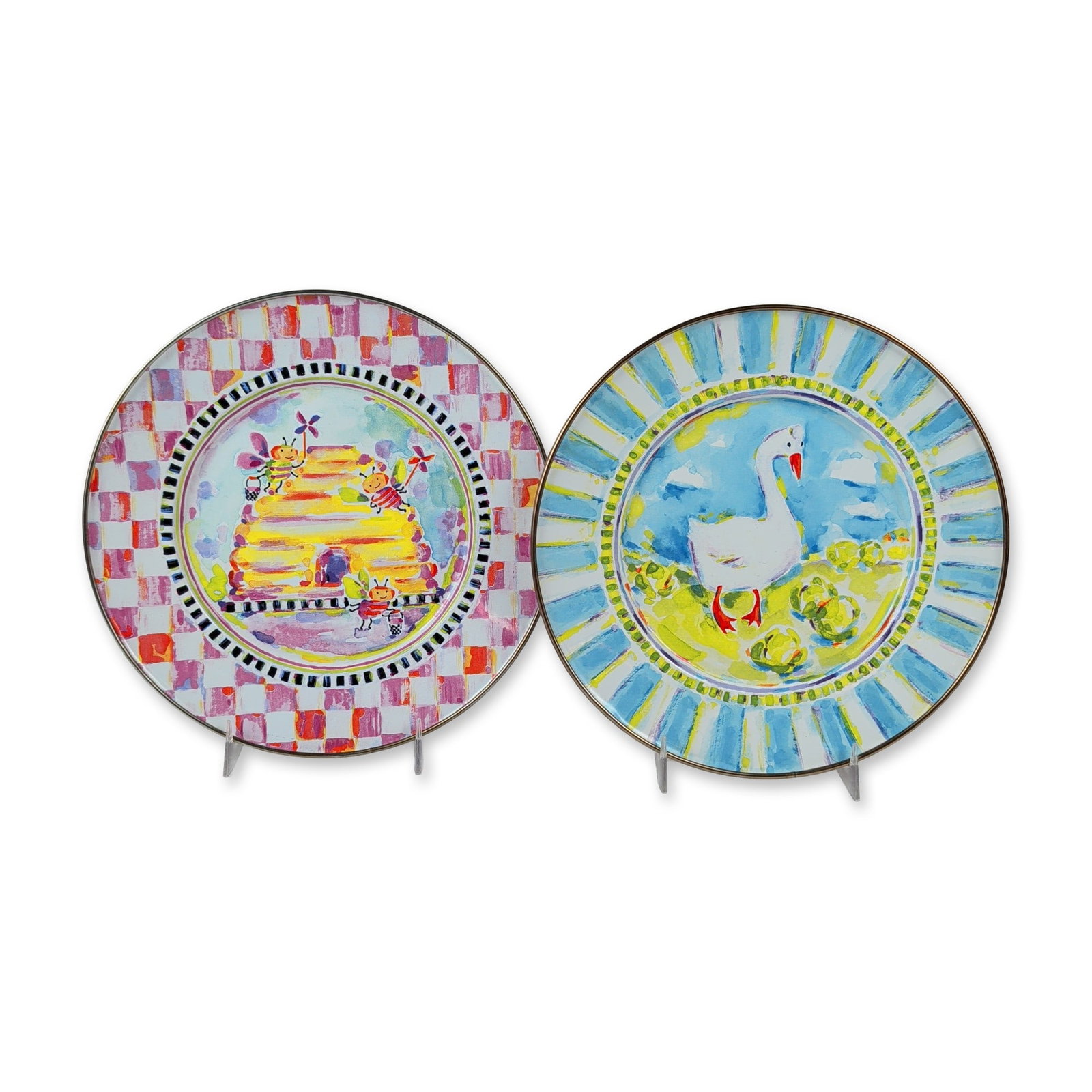 2pc MacKenzie-Childs Enamelware Plates: MacKenzie-Childs enamelware salad or dessert plates in transfer-decorated heavy-gauge steel, featuring whimsical animal motifs and bronzed stainless-steel rims. One plate displays a swan in the Myrtle