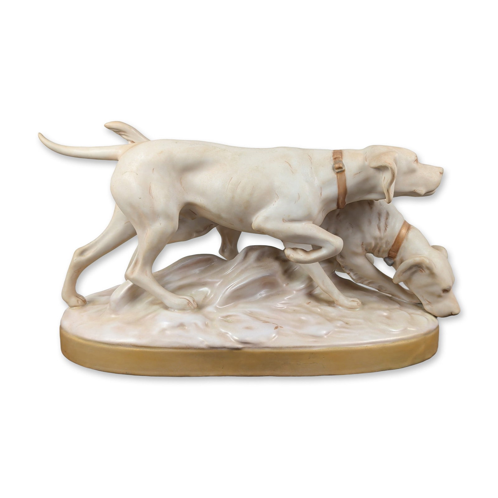 Royal Dux Porcelain Hunting Dogs Figural Grouping: A Czechoslovakian Royal Dux porcelain figural grouping depicting two hunting dogs, likely English Pointers, on a naturalistic landscape base. The dogs are rendered in active poses atop a terrain-style