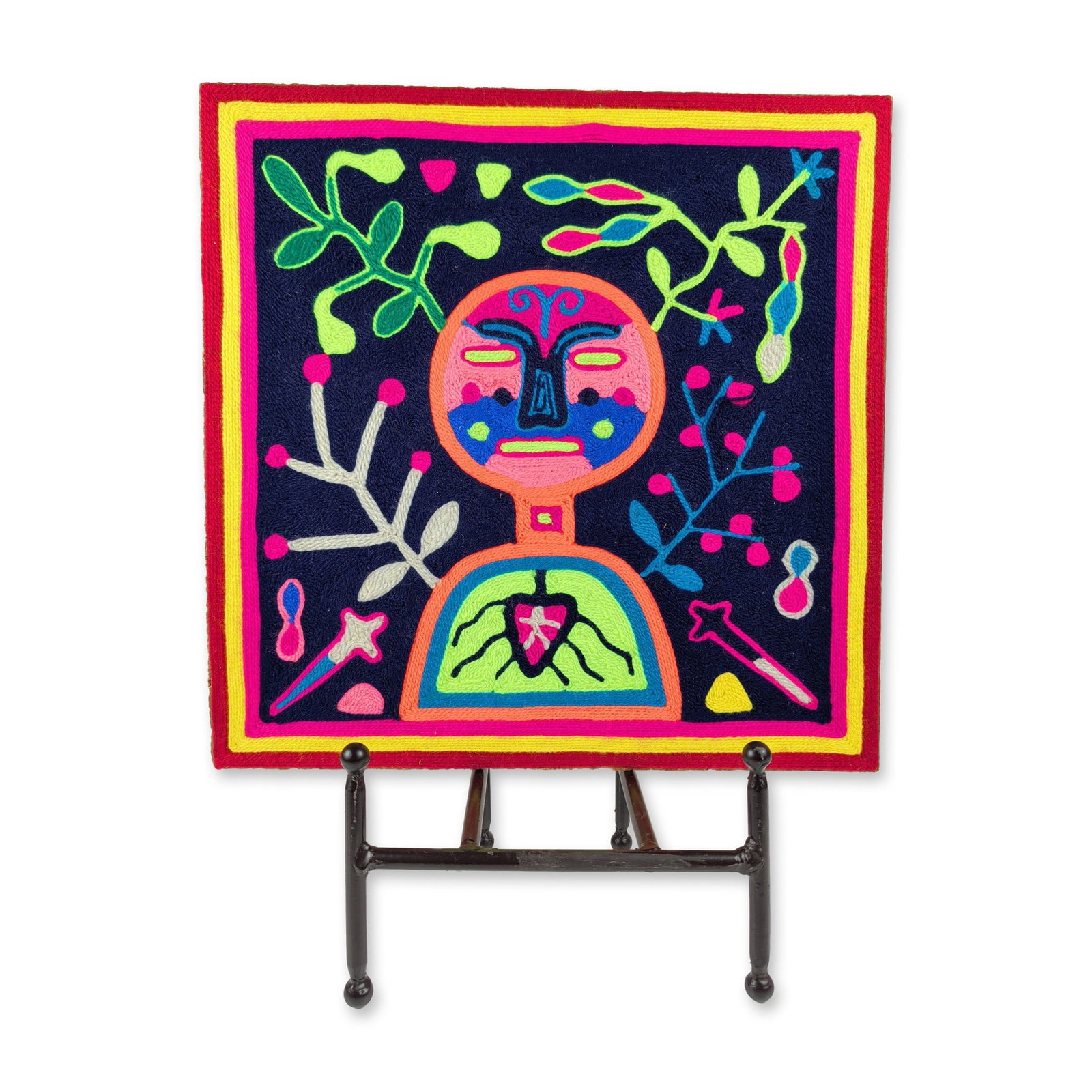 Huichol Mexican Folk Art Nakawe Goddess Nierika Yarn Painting: This square Mexican Huichol yarn painting features colored commercial yarn pressed onto a fiberboard substrate. The central iconography depicts the creator goddess Nakawe with a circular head and
