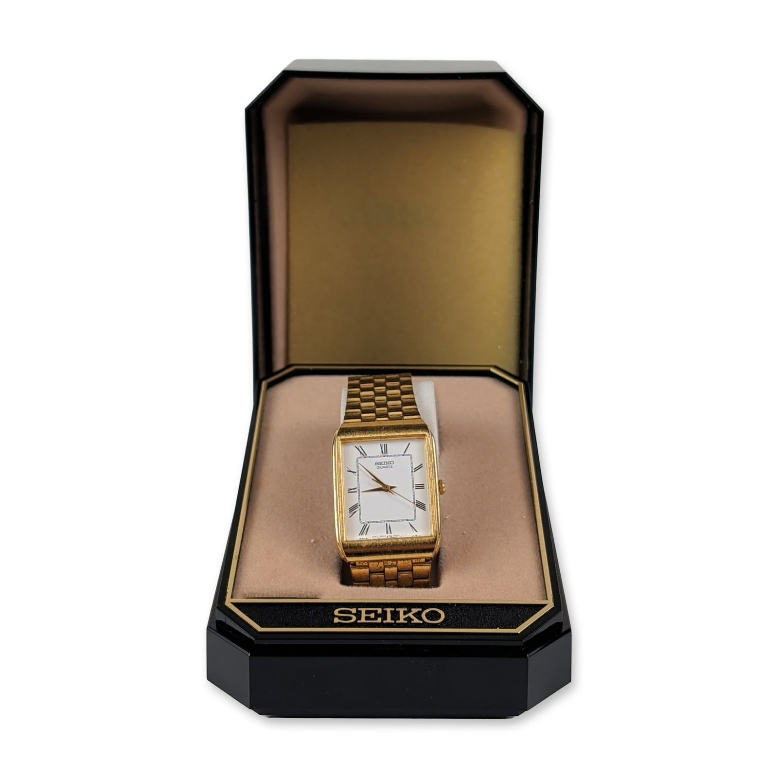 Vintage Seiko Quartz Tank Style Dress Watch: This vintage Seiko quartz dress watch features a rectangular gold-tone base metal case styled in a classic tank profile paired with an integrated matching gold-tone stainless steel link chain bracelet