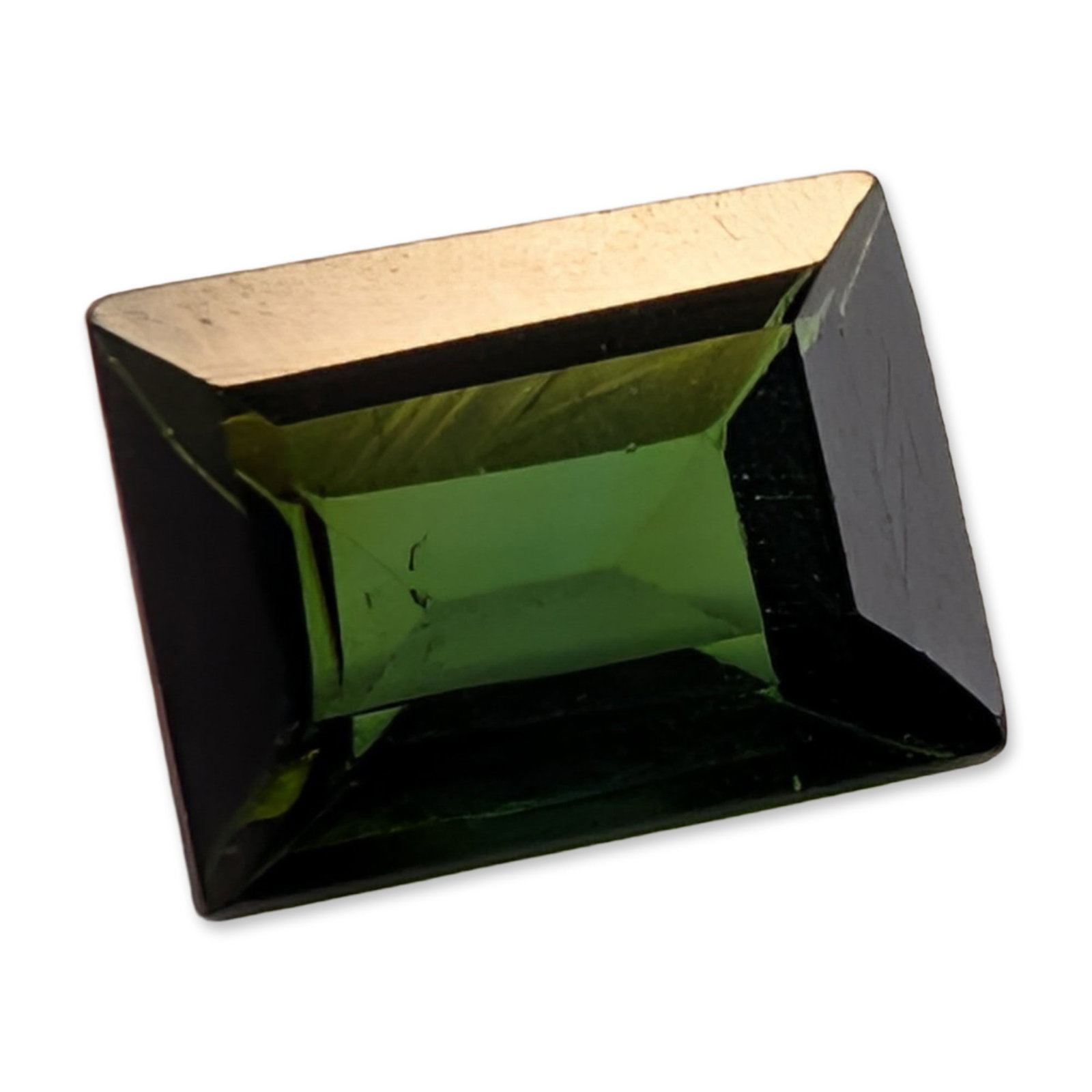 Loose Emerald Cut Green Tourmaline Gemstone: Loose faceted green tourmaline gemstone in a rectangular emerald cut. The stone displays a deep forest green color with pronounced pleochroism, appearing significantly darker when viewed along the lon