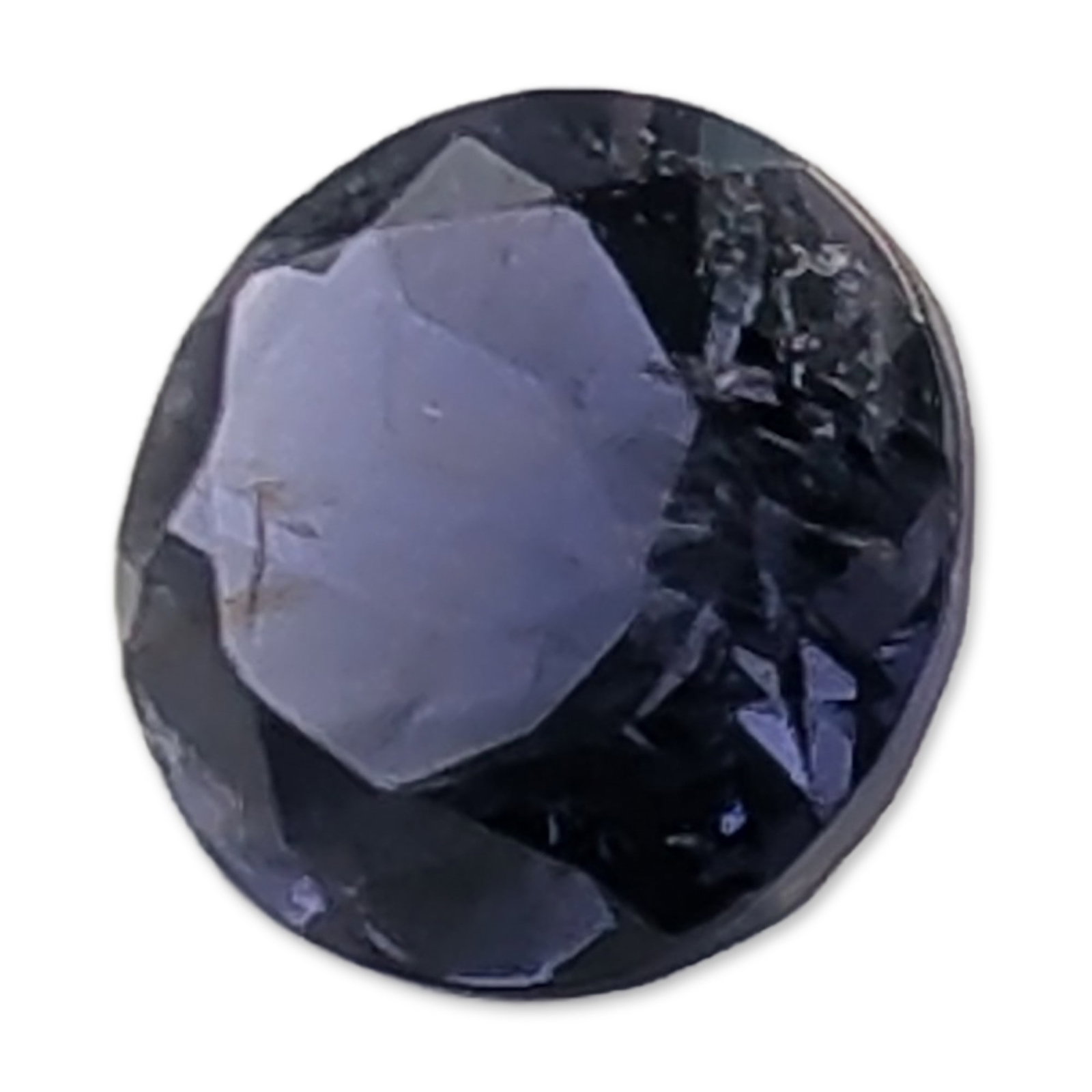 Round Faceted Violet Blue Loose Stone: Round faceted loose stone in a deep violet-blue hue with charcoal-gray undertones. . It features a traditional round brilliant-style facet arrangement. 0.7ct Dimensions: 6 mm W