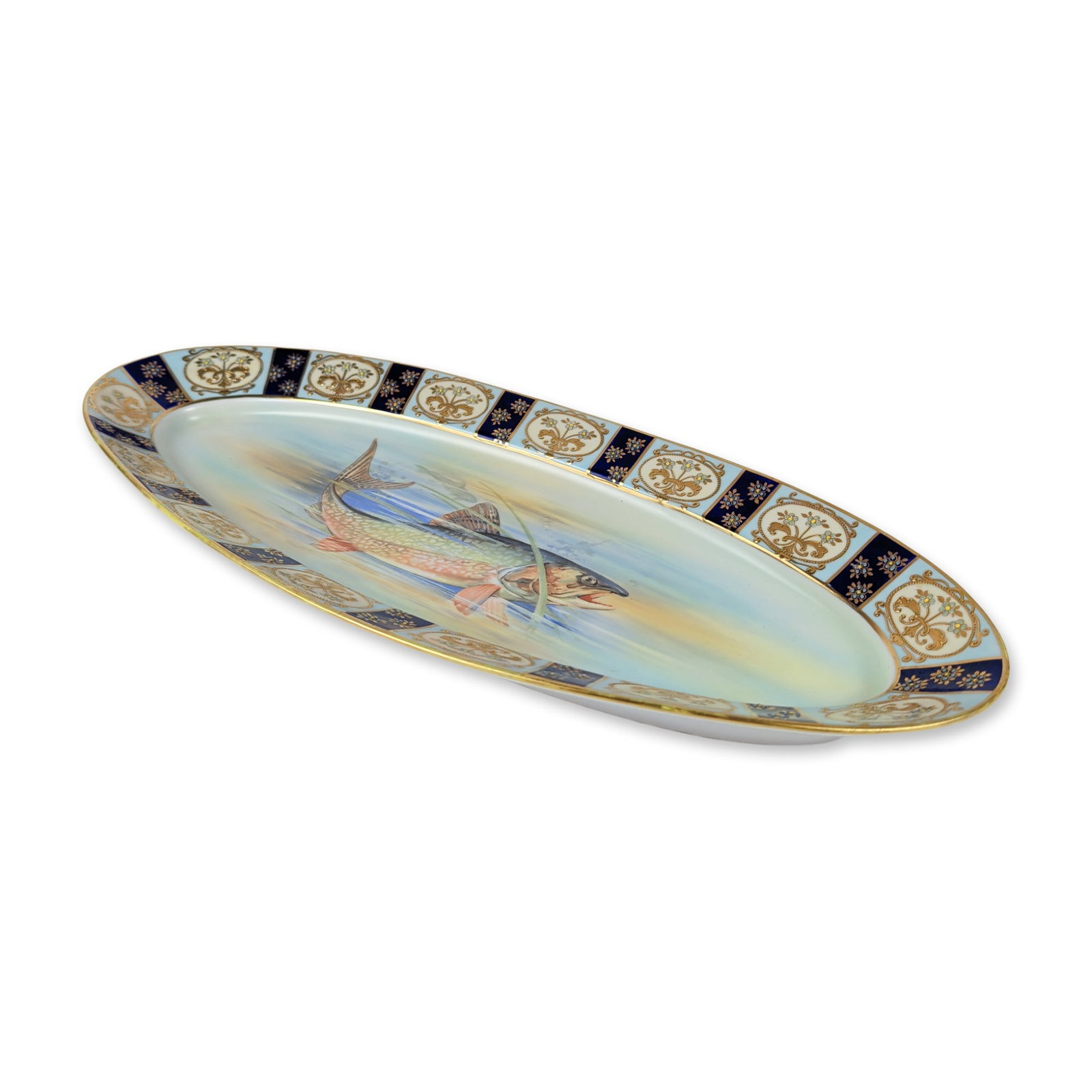 Large Noritake Hand Painted Porcelain Fish Platter: Japanese Noritake porcelain oval fish platter featuring a hand painted central scene of a swimming trout in an aquatic landscape. The piece is decorated with a wide border of alternating cobalt blue-