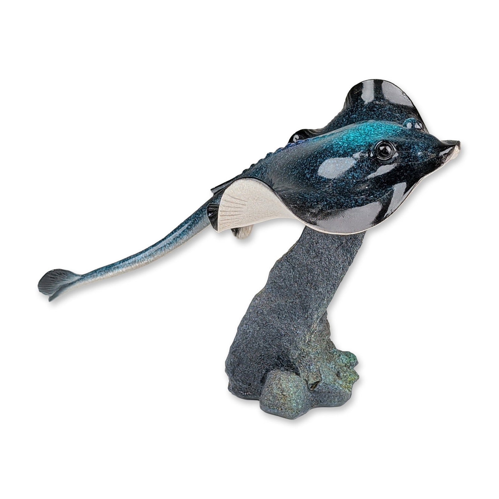 Iridescent Glazed Ceramic Stingray Art Sculpture: Ceramic figurine of a stingray depicted in a swimming pose. The dorsal surface features a high-gloss iridescent glaze with shimmering teal and deep blue flecks over a dark ground. The underside of the